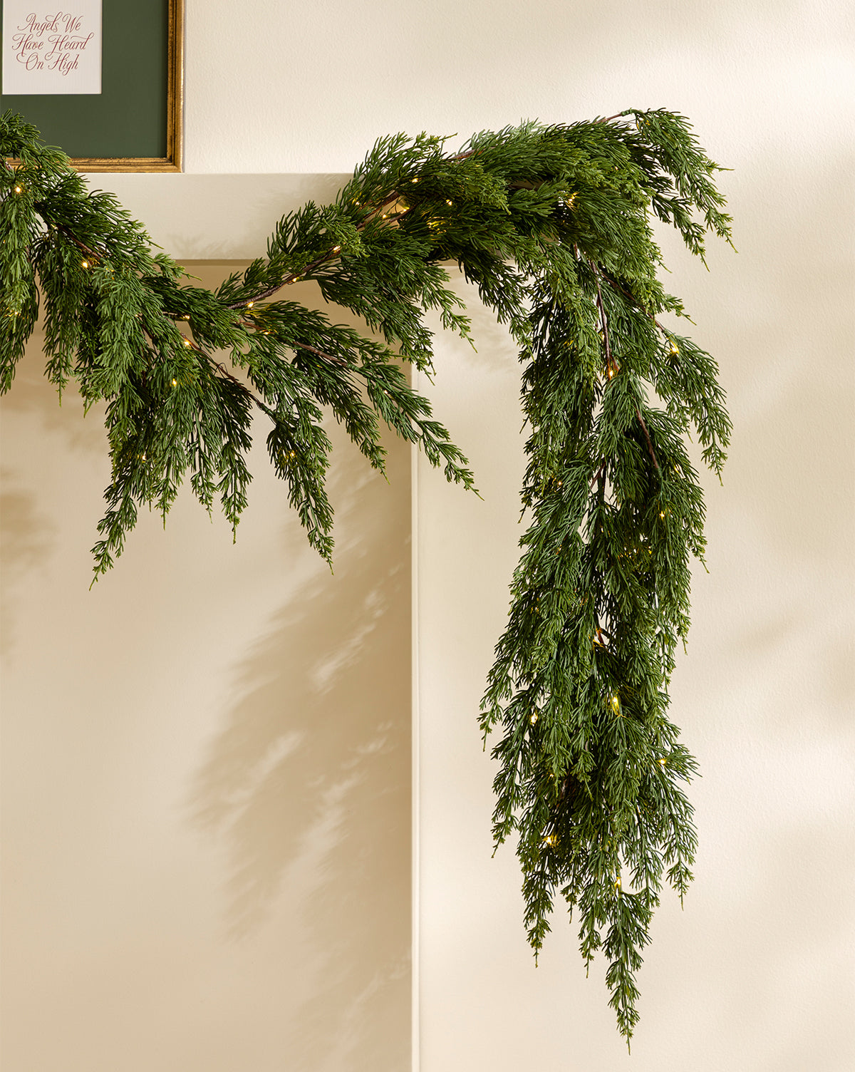 A framed picture with cursive writing is partially seen in the top left corner, completing the holiday home decor, by McGee & Co.