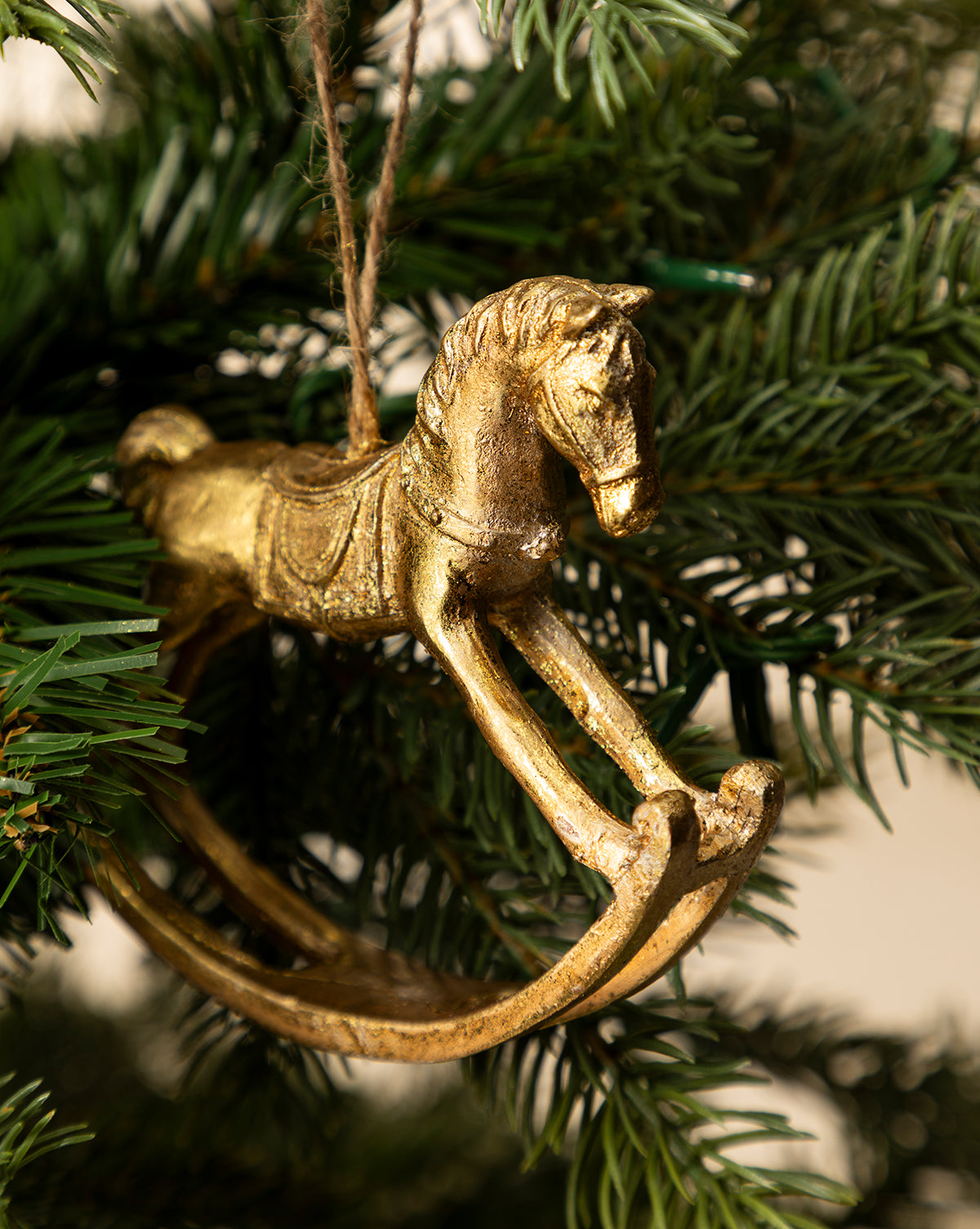 Add classic charm to your holiday décor with the Gold Rocking Horse Ornament, a vintage-style ornament that hangs from a string on your Christmas tree, by McGee & Co.