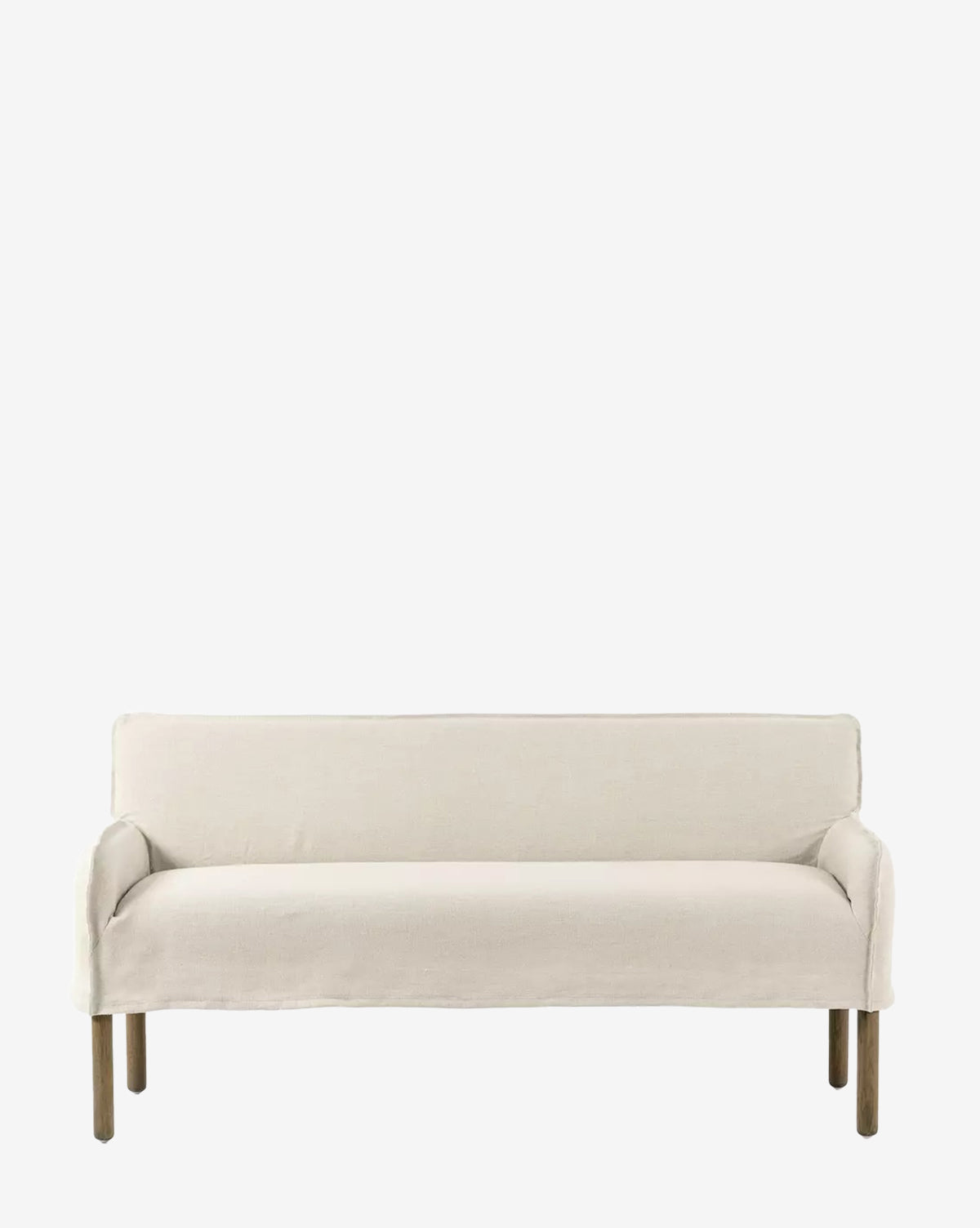 The Aiken Slipcover Bench by Four Hands features a cushioned seat in off-white linen upholstery, minimalist modern design, and simple wooden legs, shown against a plain white background. McGee & Co.