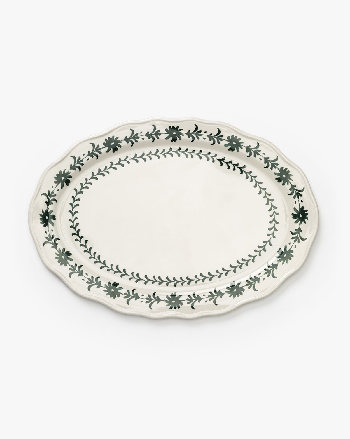 The Alba Melamine Platter is an oval plate with a scalloped edge, adorned with green floral vine motifs along the rim and inner border on a white background, by McGee & Co.