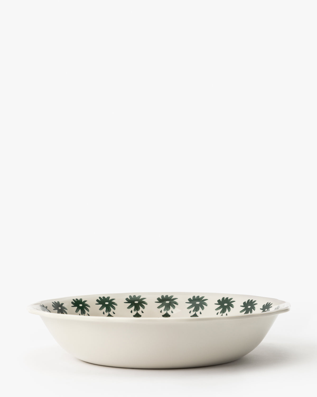 The Alba Melamine Serving Bowl is a shallow, round dish featuring scalloped edges and dark green floral patterns around the inner rim, all set against a plain white background, by McGee & Co.