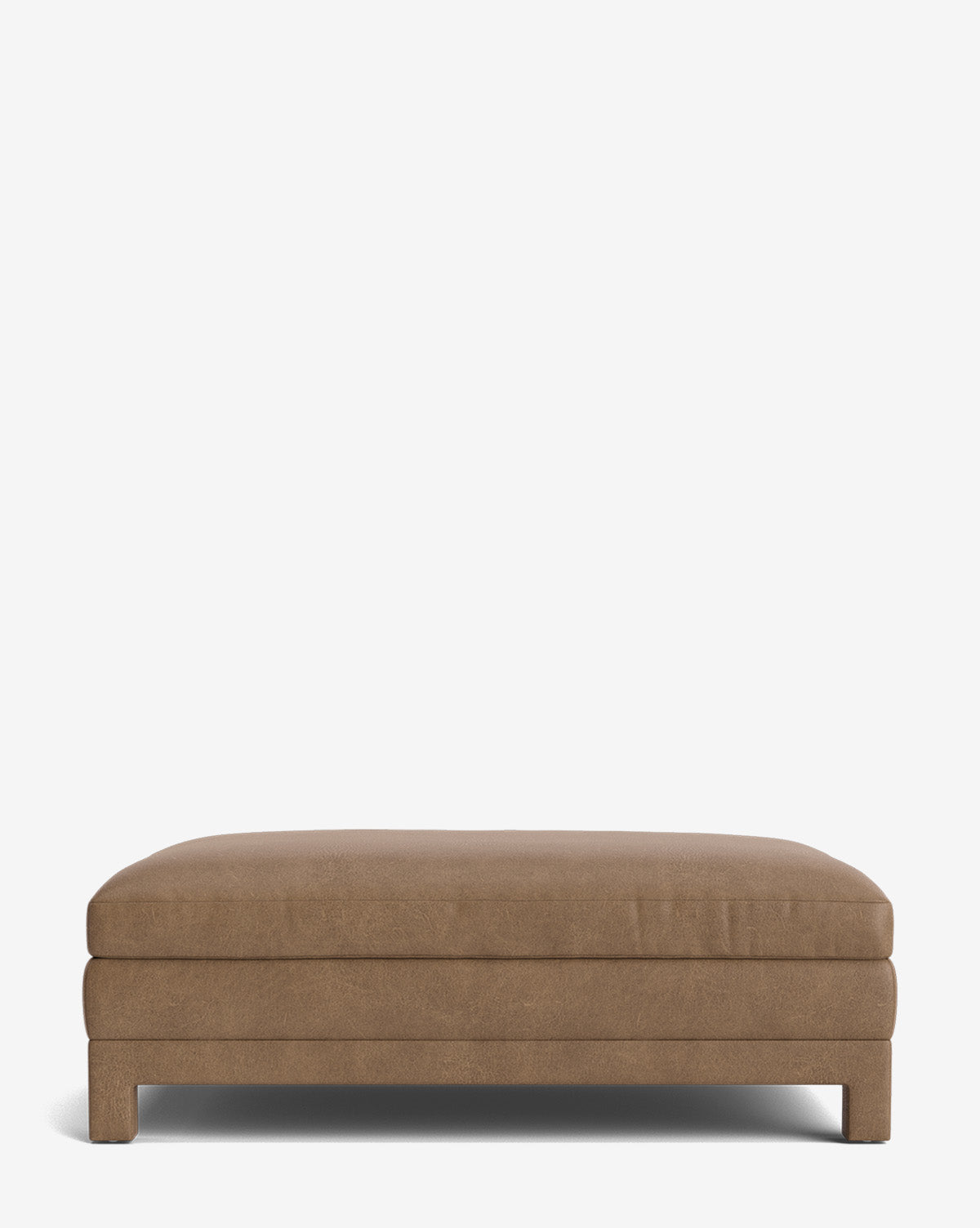 The Appoline Ottoman is a rectangular, low-profile piece with light brown upholstery, simple design, and short legs, shown against a plain white background by McGee & Co.