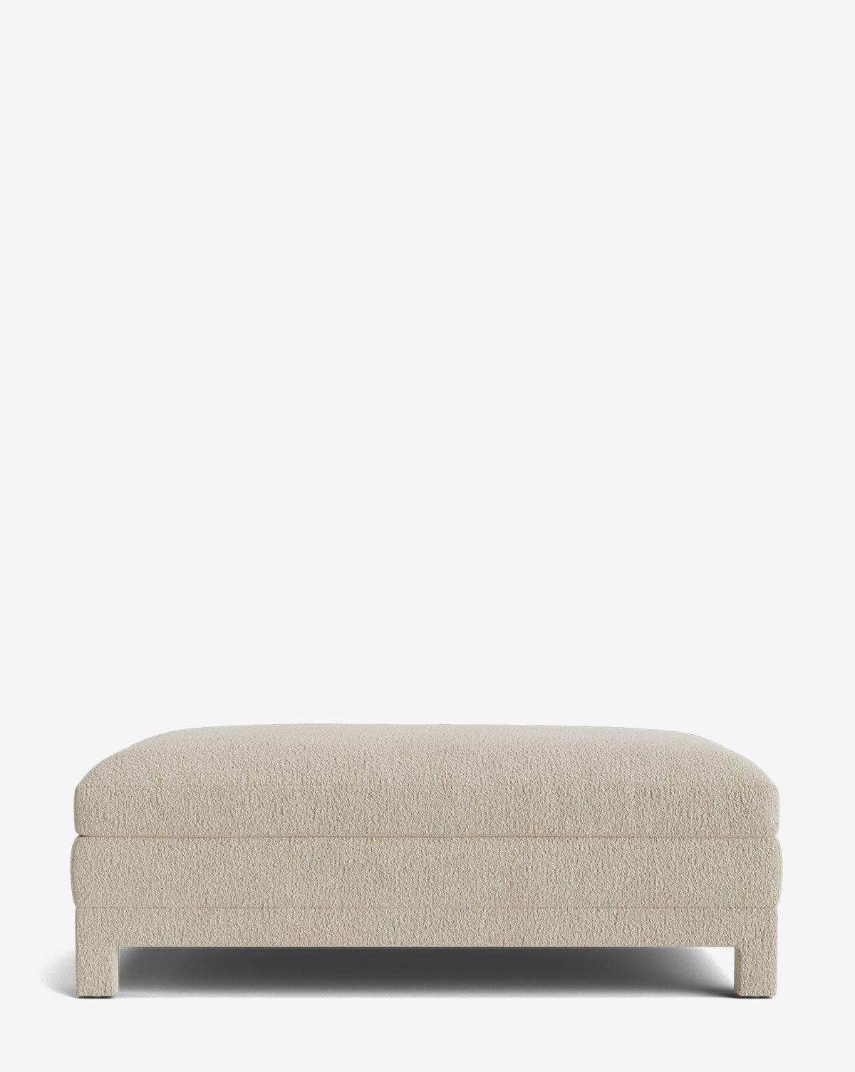 The Appoline Ottoman is a rectangular, light beige piece featuring short, sturdy legs and a simple modern design, shown against a plain white background by McGee & Co.