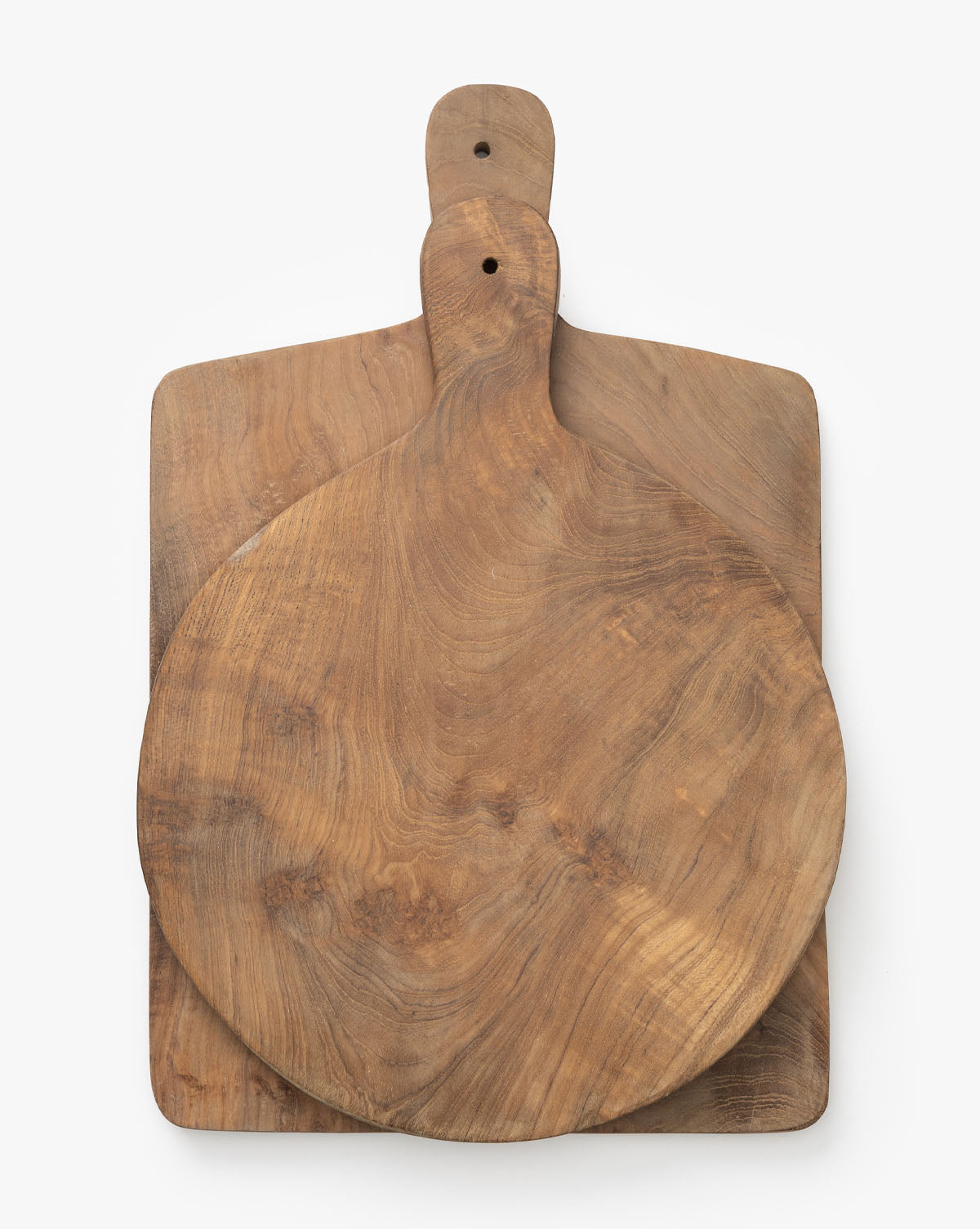 Two Boylan Bread Boards are stacked on a white background; the top is a round kitchen bread board with a handle, and the bottom is rectangular with a handle. Both display an attractive natural wood grain pattern.
