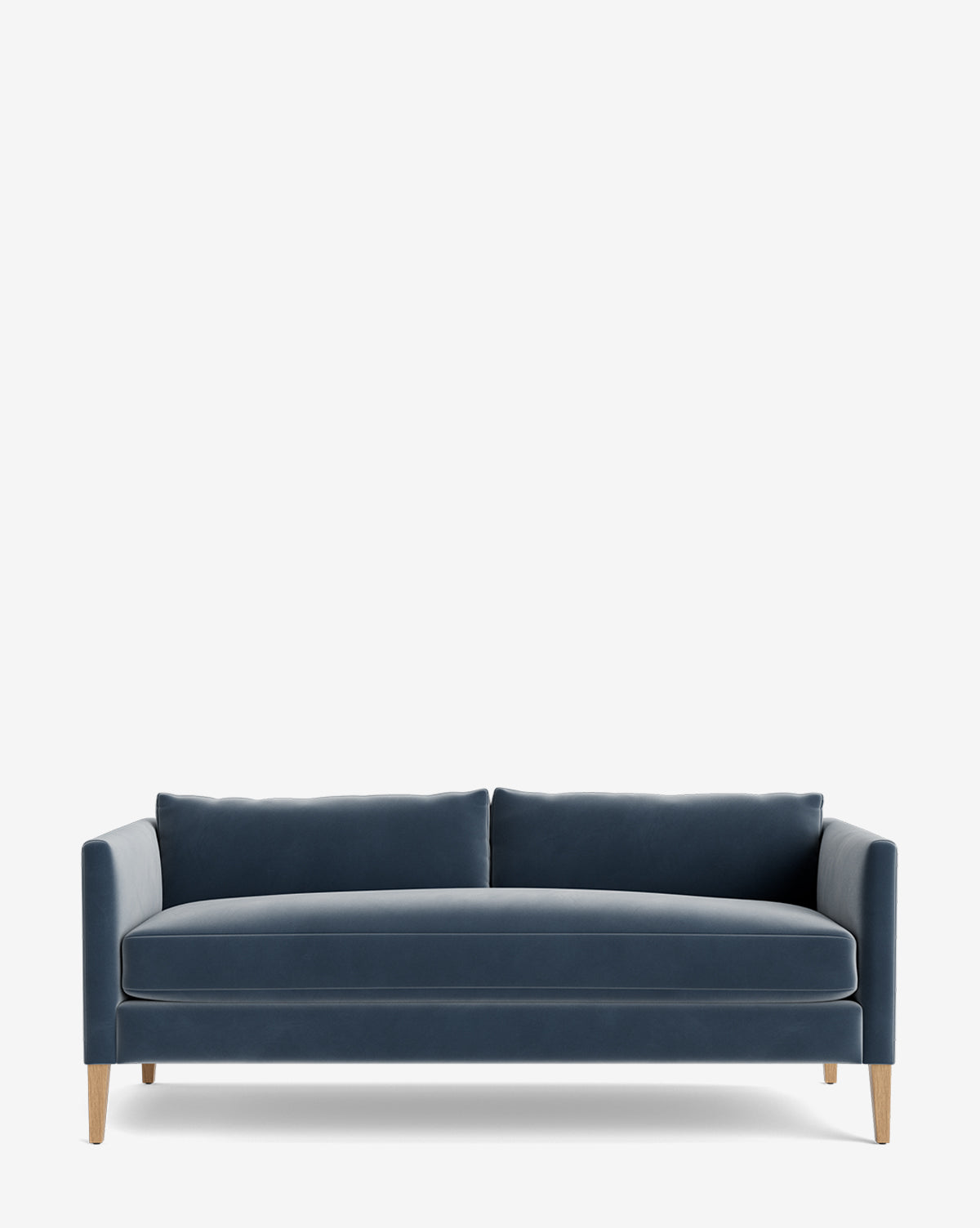 The Cade Sofa 80 is a modern blue velvet sofa featuring a straight back, two large down-wrapped seat cushions, and slim wooden legs, shown against a plain white background by McGee & Co.