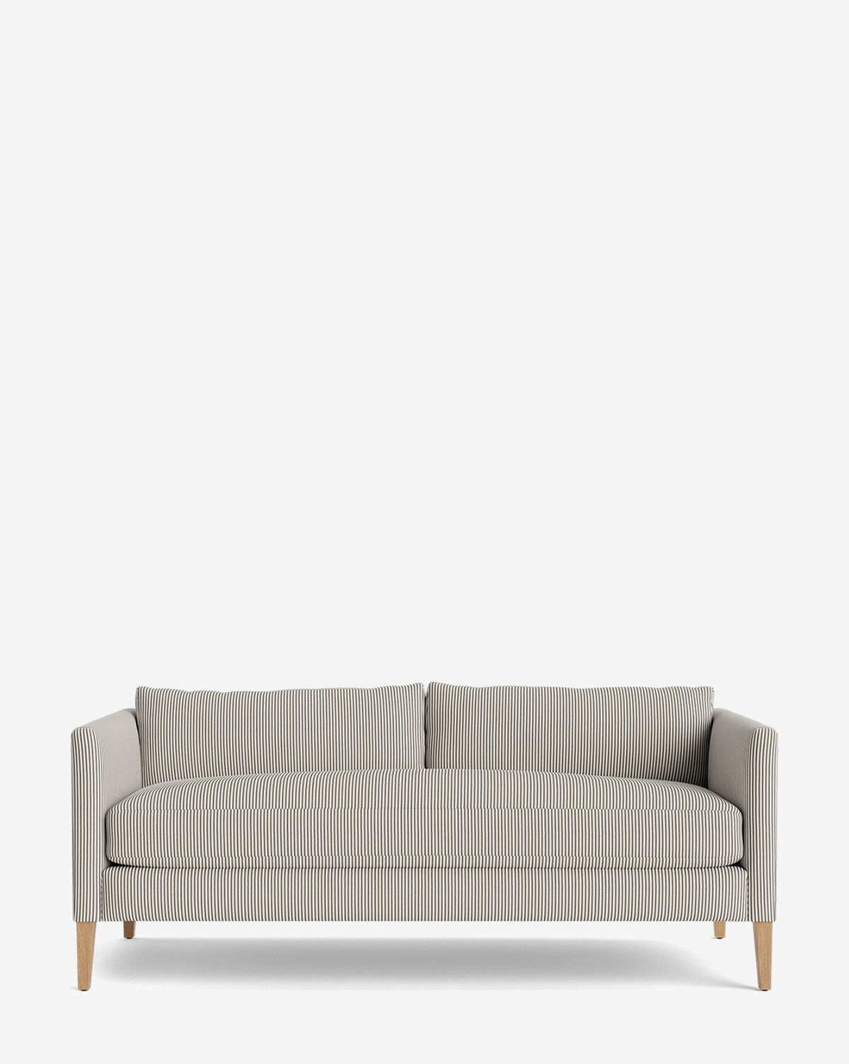 The Cade Sofa 80 features slim wooden legs and light gray and white pinstriped upholstery. This down-wrapped design has straight arms, two back cushions, and a minimalist look, shown against a plain white background by McGee & Co.