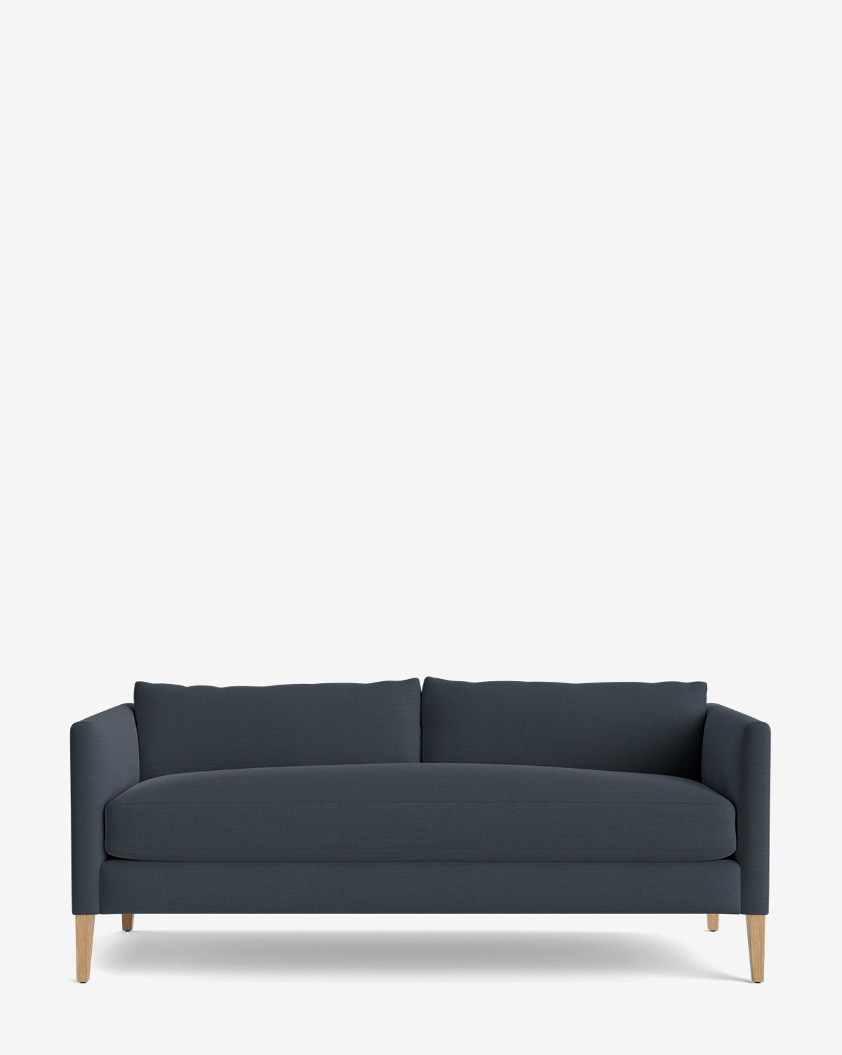 The Cade Sofa 80 is a modern, down-wrapped dark blue sofa with straight arms, two seat and back cushions, and light wooden legs, displayed against a plain white background by McGee & Co.