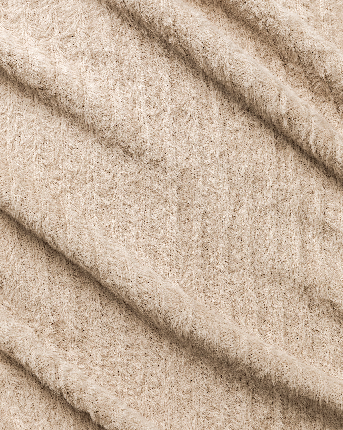 A close-up of the Caro Throw's soft, beige knit fabric with a subtle cable pattern and gentle diagonal folds—perfect as a neutral accent to add cozy decor to any room, by McGee & Co.