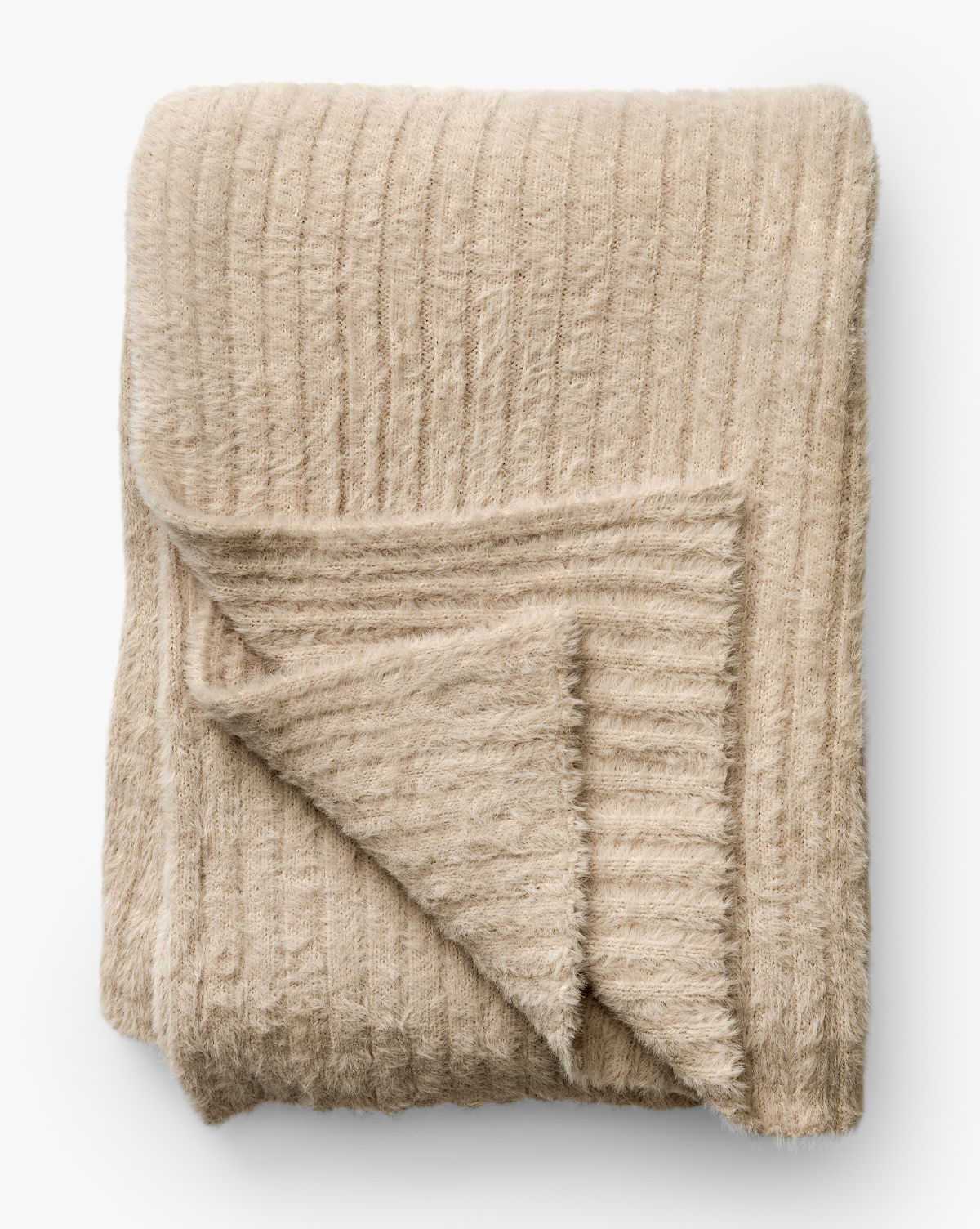 A corner is flipped up to display its texture and thickness, making it an ideal accent for cozy home decor, by McGee & Co.