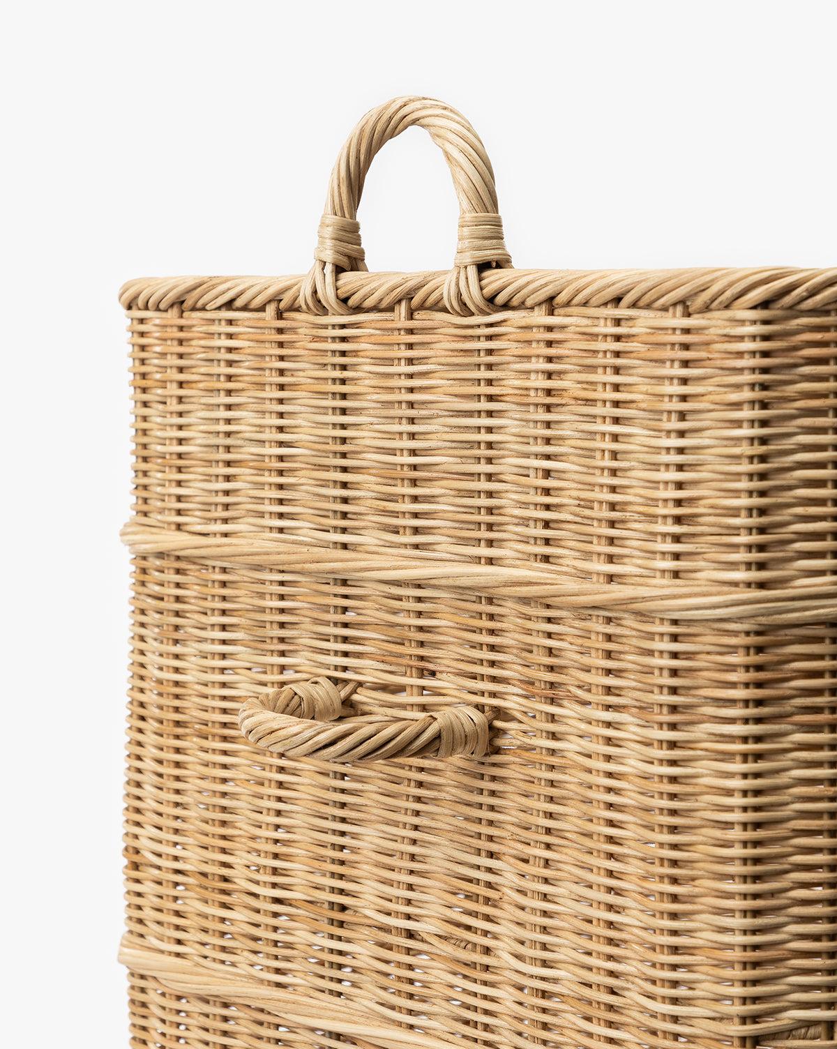 A close-up of the Chiara Laundry Basket, a rectangular wicker hamper with a natural finish, featuring a woven top handle and side handle, perfect for any laundry room, set against a white background, by McGee & Co.