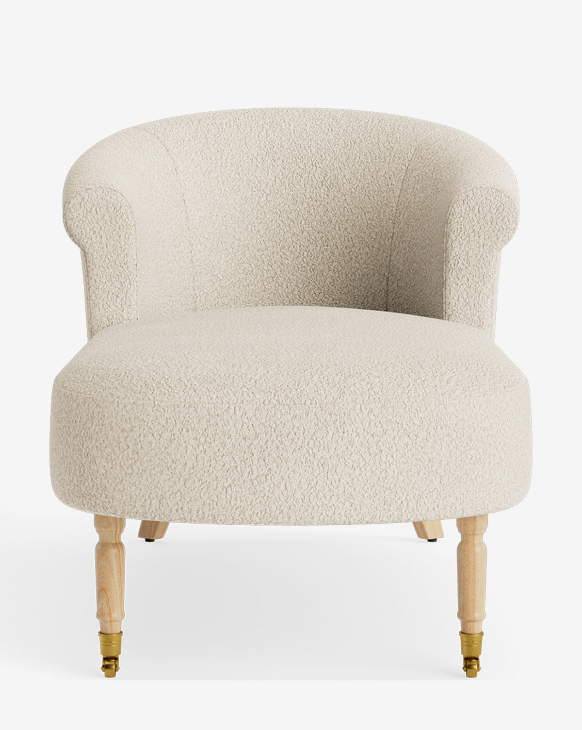 The Clemence Chaise is a cream-textured upholstered accent chair, inspired by the classic chaise lounge with a curved back, rounded arms, and four light wooden legs with brass casters—a stylish choice for customizable furniture lovers, by McGee & Co.