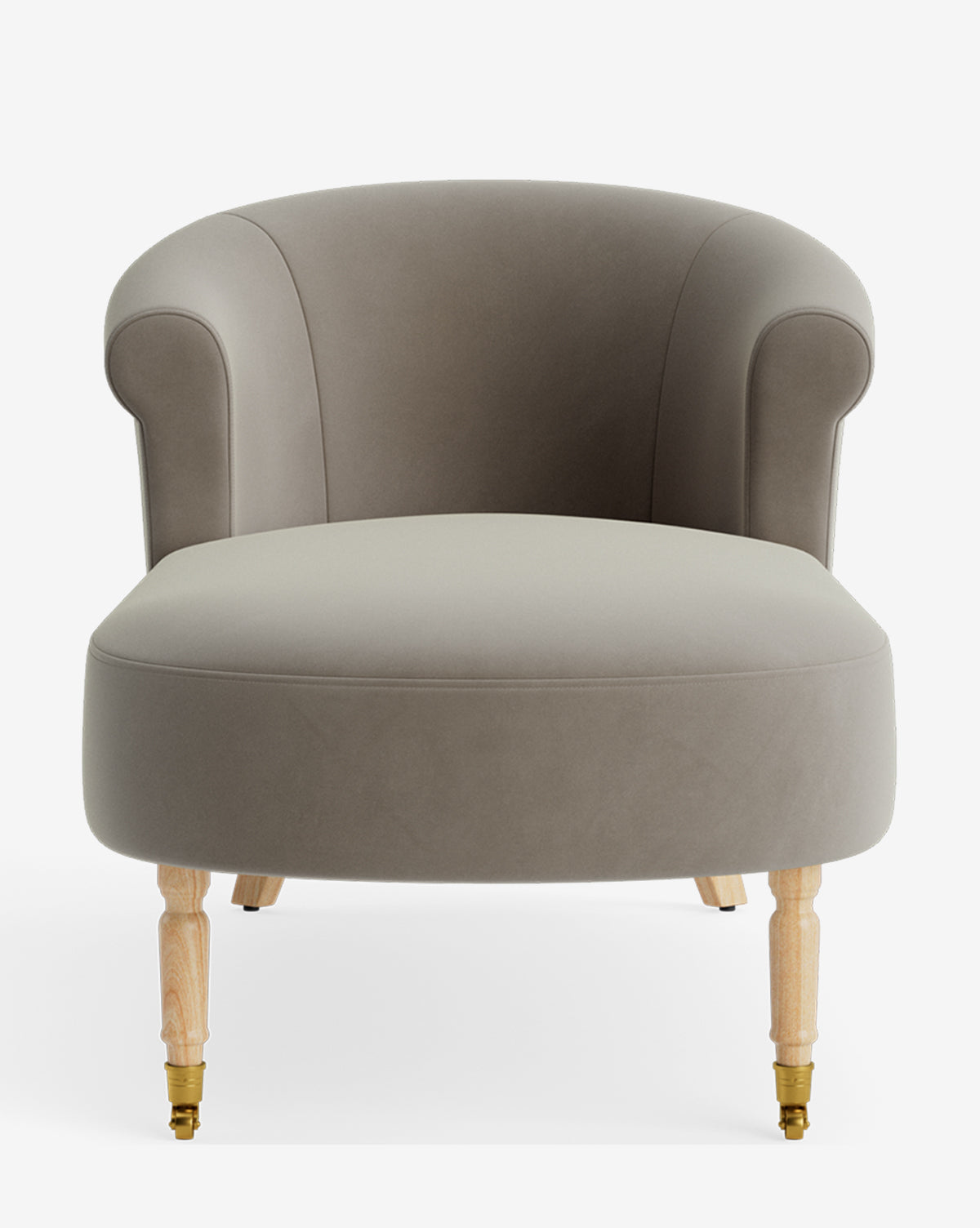 The Clemence Chaise is a modern accent chair with a rounded back, soft taupe upholstery, and light wooden legs with front brass casters, displayed against a white background. Ideal for customizable furniture collections by McGee & Co.
