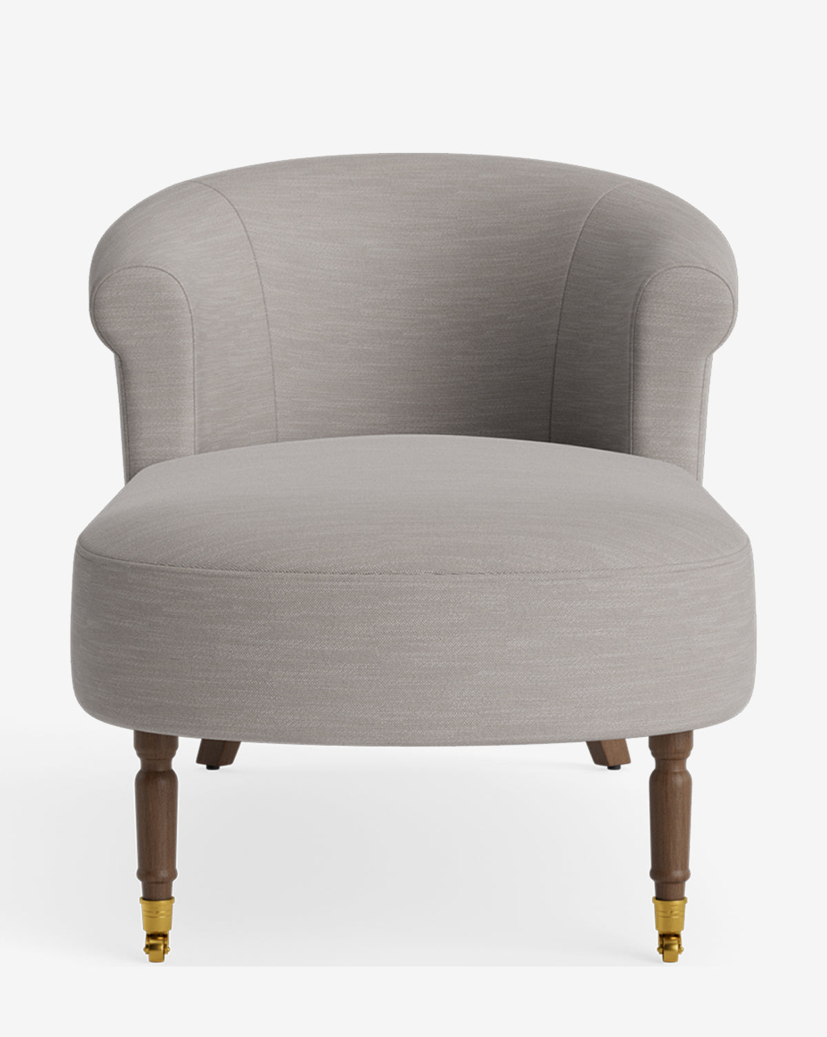 The Clemence Chaise is a modern, light gray upholstered armchair with a curved backrest, rounded arms, and wooden legs with brass casters on the front—a customizable centerpiece for any contemporary space, by McGee & Co.