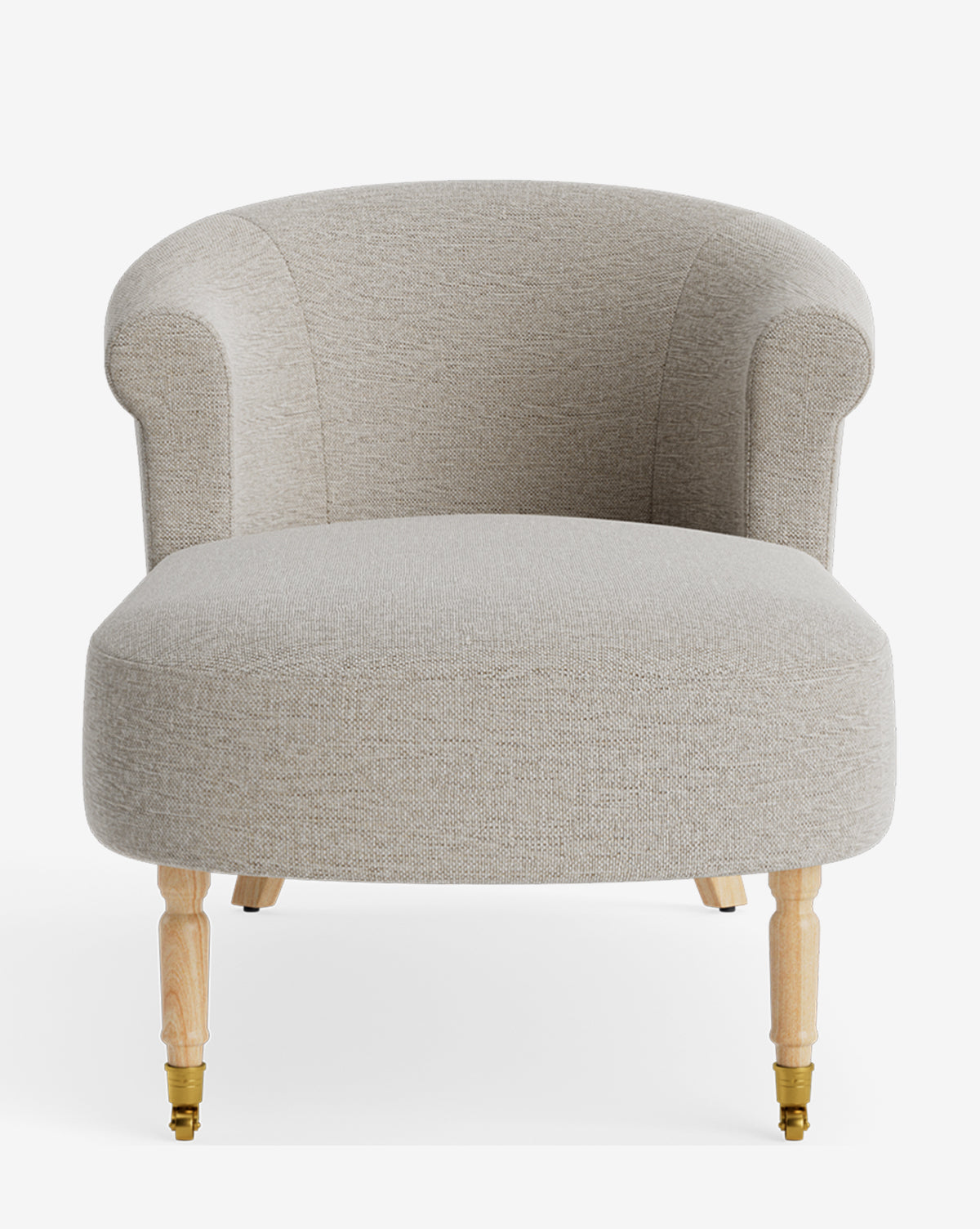 A light beige upholstered accent chair with a curved back, rounded arms, and wooden legs—front two with brass casters—pairs beautifully with customizable furniture or the elegant Clemence Chaise, by McGee & Co.