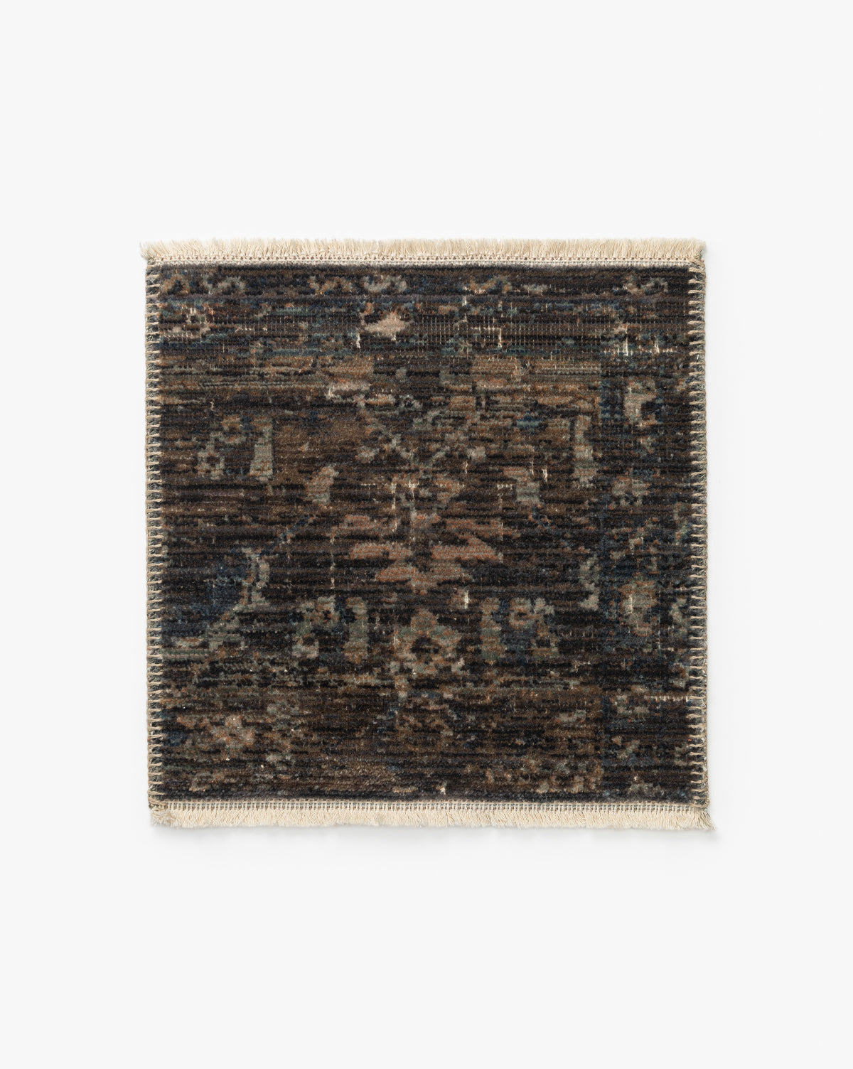 The Conley Lagoon Rug Swatch is a rectangular sample with a dark, distressed pattern in brown, black, and blue, showcasing an intricate motif and beige fringe on the short edges, shown on a white background by McGee & Co.