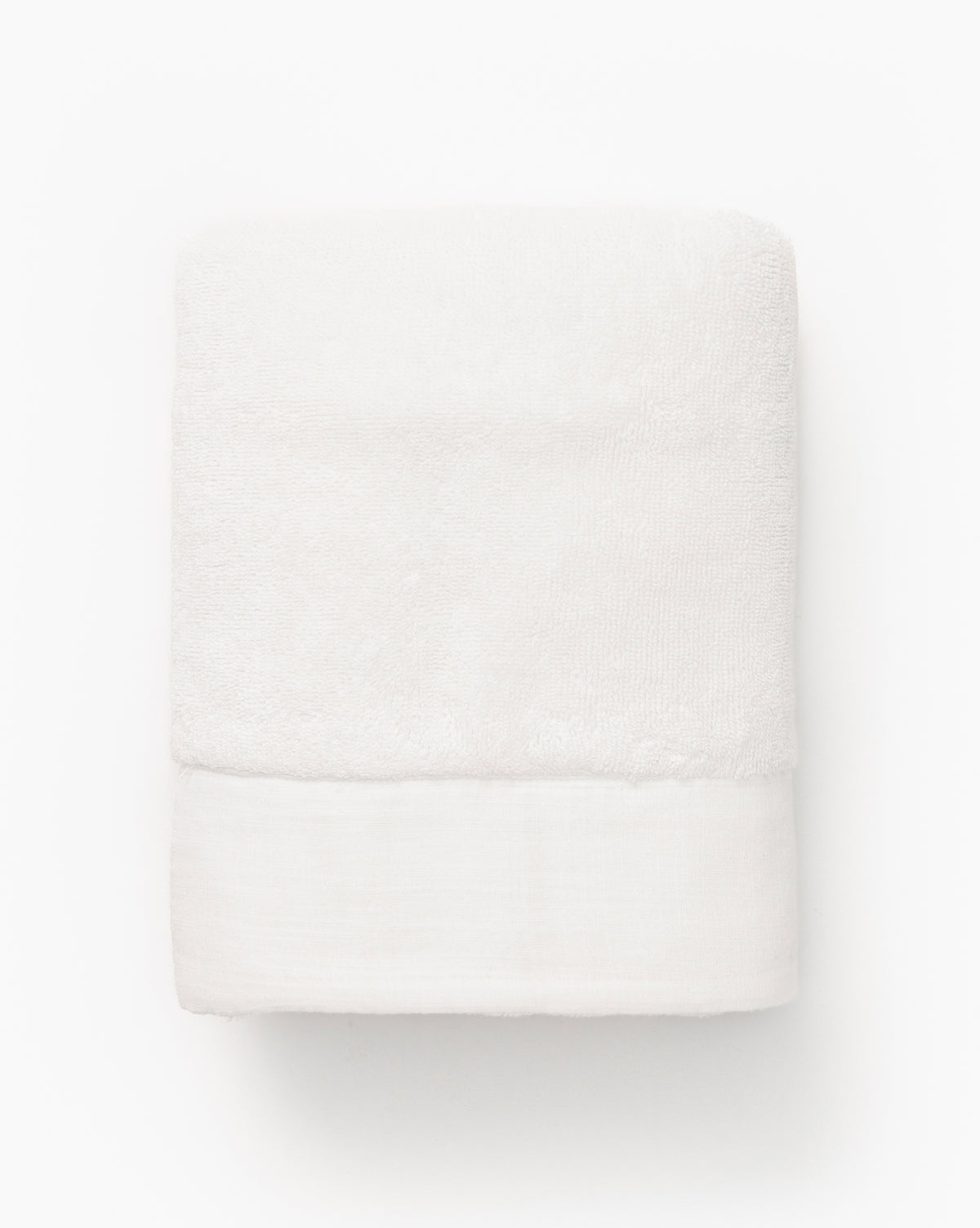 A neatly folded white towel from the Dedra Bath Collection, featuring a smooth border, is displayed against a plain background.