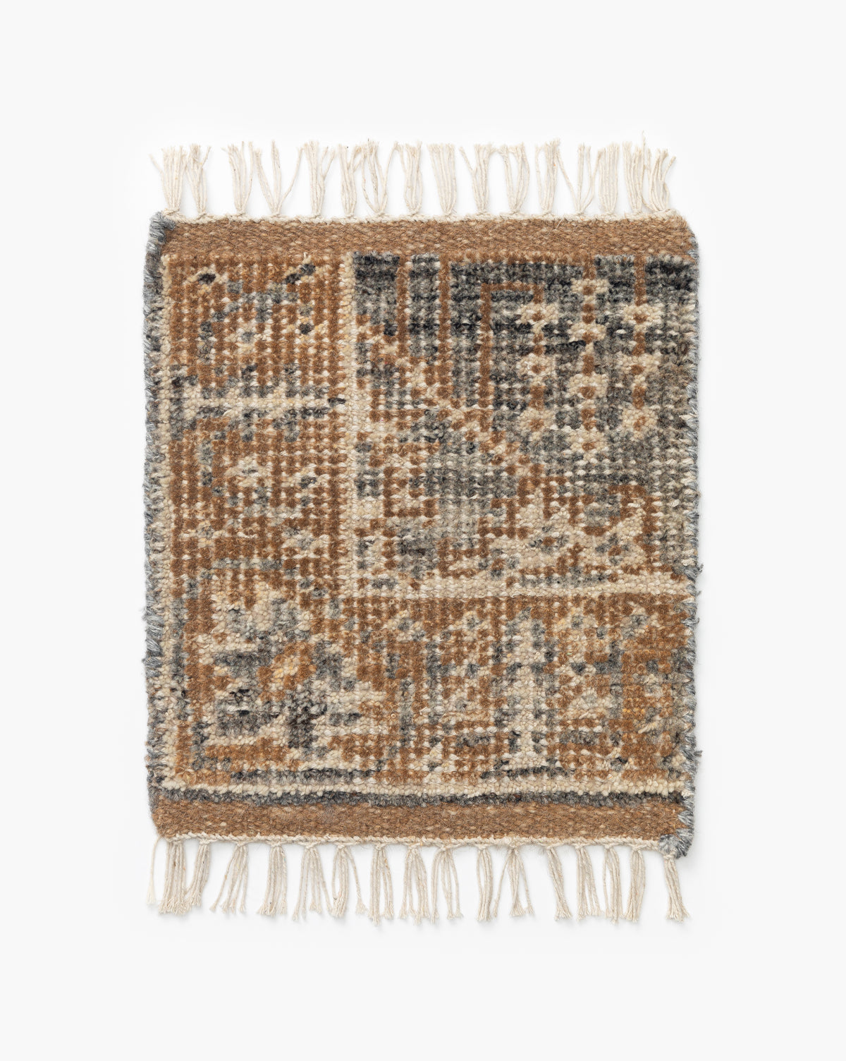 The Elison Hand-Knotted Rug Swatch showcases artisan details with a geometric, tribal-inspired pattern in brown, beige, and gray, featuring traditional motifs and white fringe on the top and bottom edges by McGee & Co.
