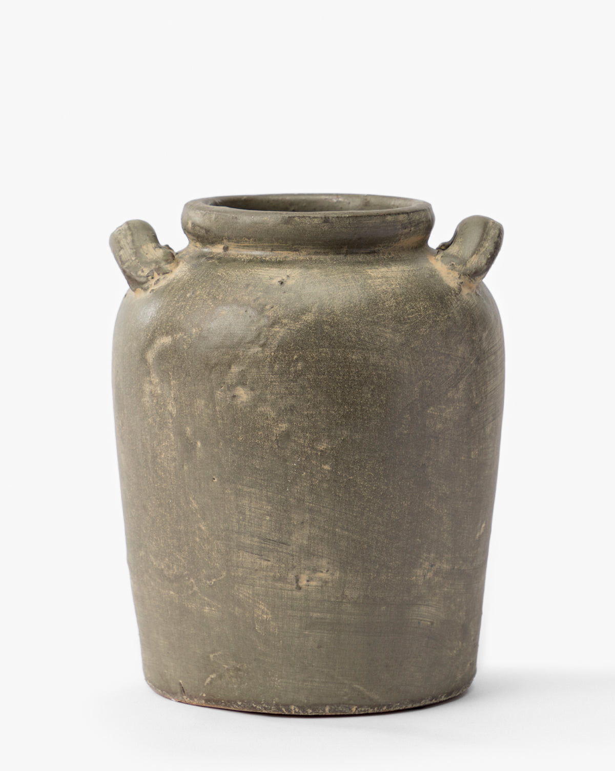 The Emilio Urn is a rustic olive-green ceramic jar with a rough texture, a wide cylindrical body, and two small top handles—an elegant shelf accessory ideal for vintage decor—set against a plain white background, by McGee & Co.
