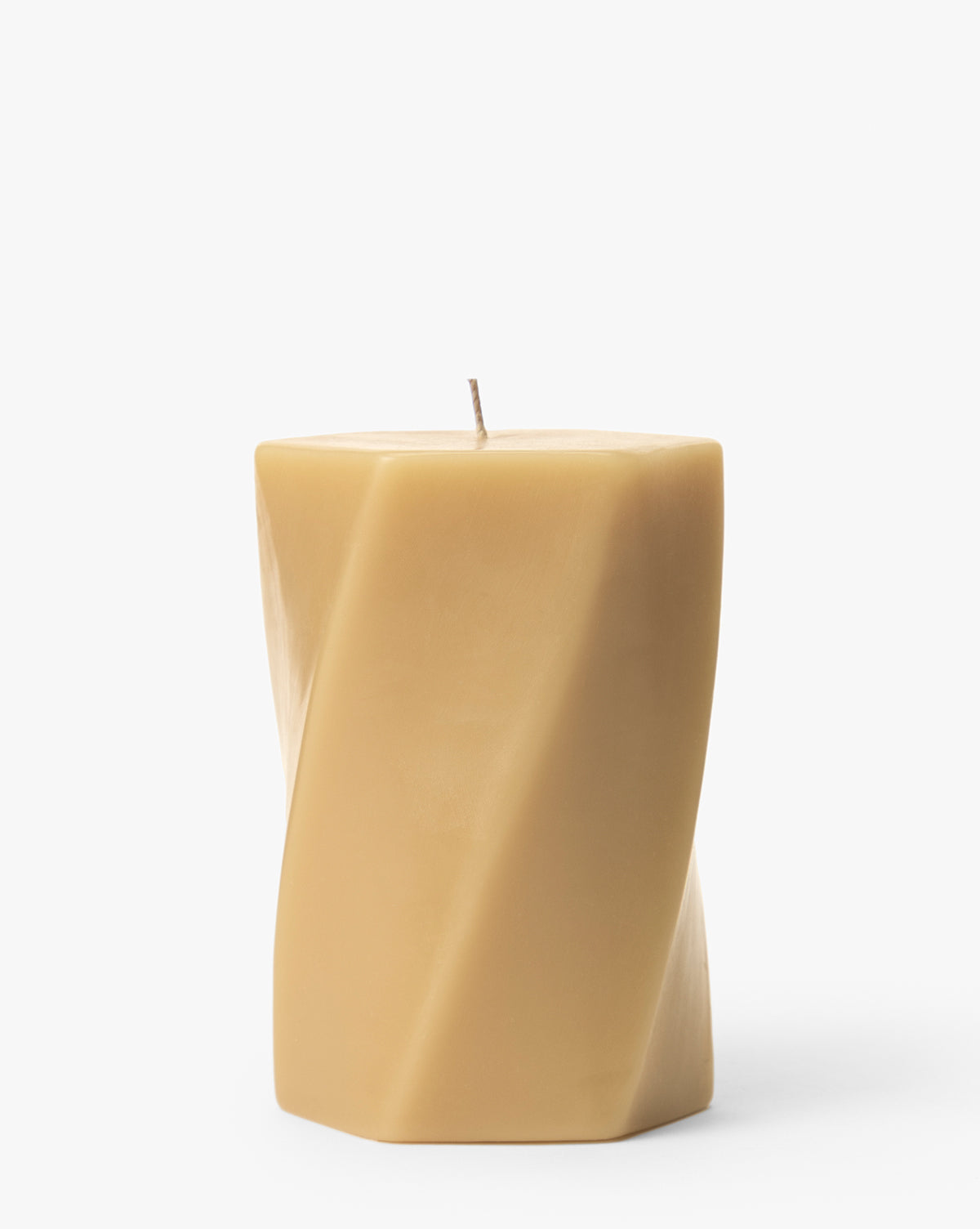 The Errol Wax Pillar Candle is a beige, square-shaped candle with a twisted design, displayed upright on a white background—perfect for adding a modern touch to any space, by McGee & Co.