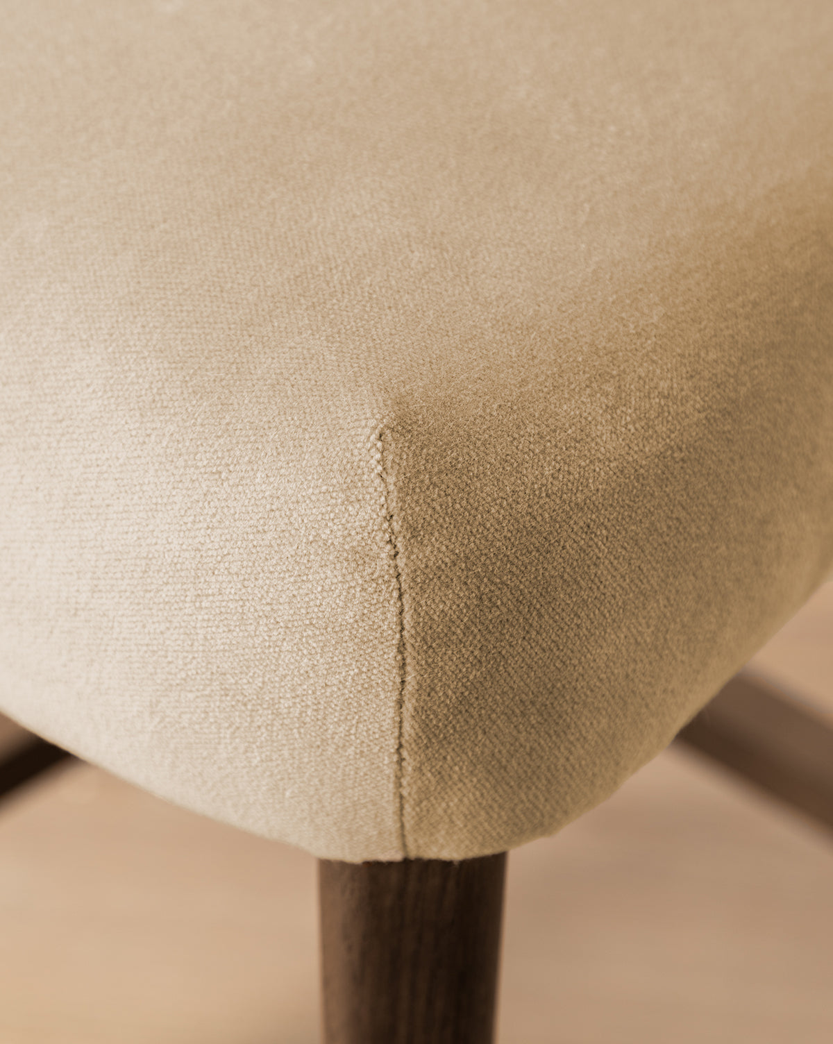 Certainly! Here’s your revised sentence with the exact string McGee & Co. blended into the end: Close-up of a beige upholstered cushion on the Makerspalm Etienne Stool (Ready to Ship), highlighting its textured fabric, neat seam, and dark wooden legs—a vintage-inspired, customizable kitchen seat by McGee & Co.