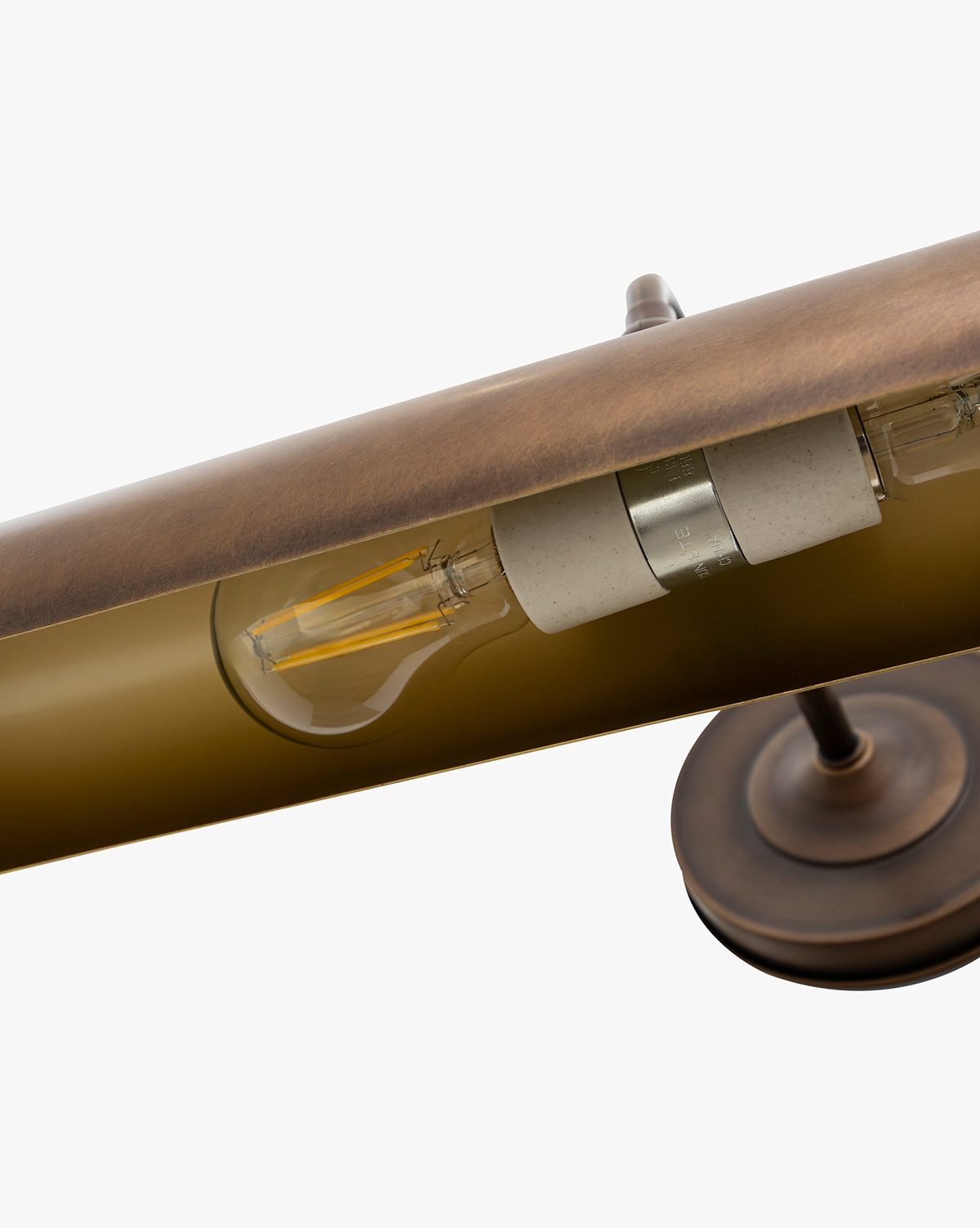 Close-up of the Gallery Picture Sconce, featuring a burnished bronze finish, visible filament bulb, and cylindrical socket. The lamp base and a section of the horizontal arm are shown for detail, by McGee & Co.