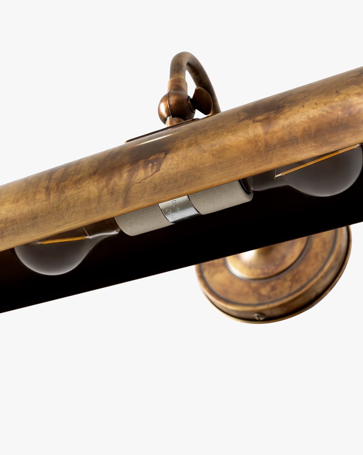 Close-up of the Gallery Picture Sconce, featuring burnished bronze details, two exposed bulbs, and a weathered antique finish for a vintage-inspired look, by McGee & Co.