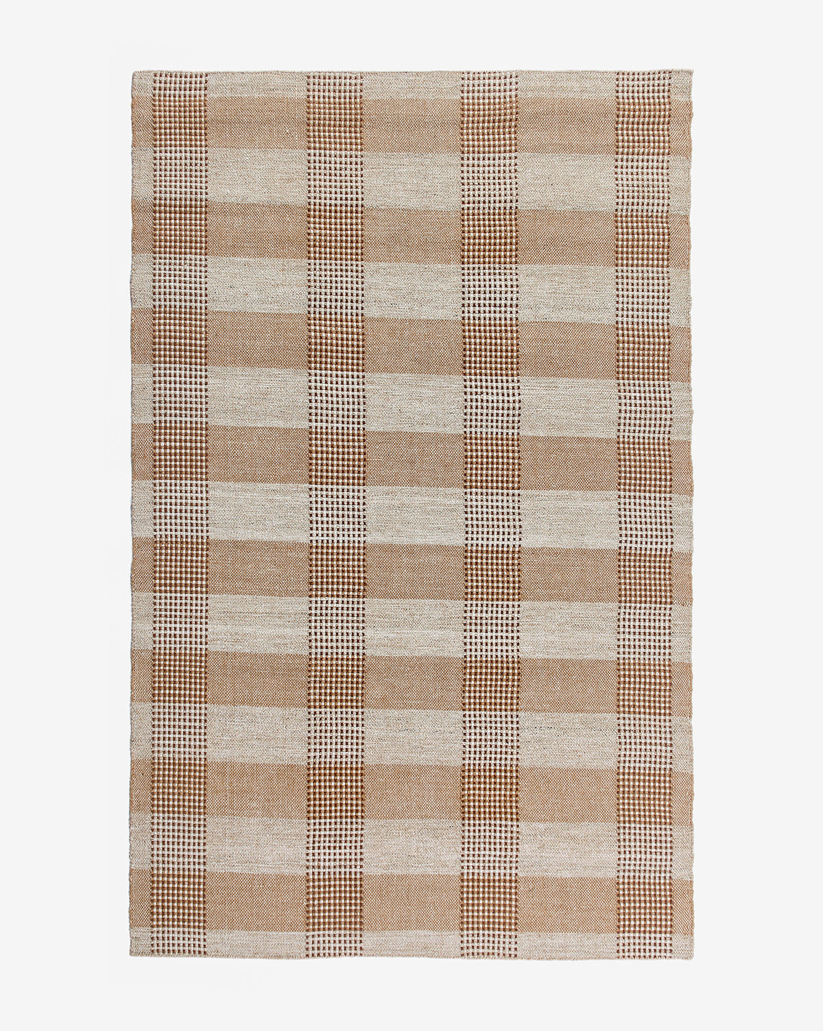 The Hargrove Handwoven Indoor/Outdoor Rug features a rectangular plaid checker pattern in tan, brown, and cream, with large alternating squares and lines. Made from durable PET fibers, it’s shown photographed on a white background.