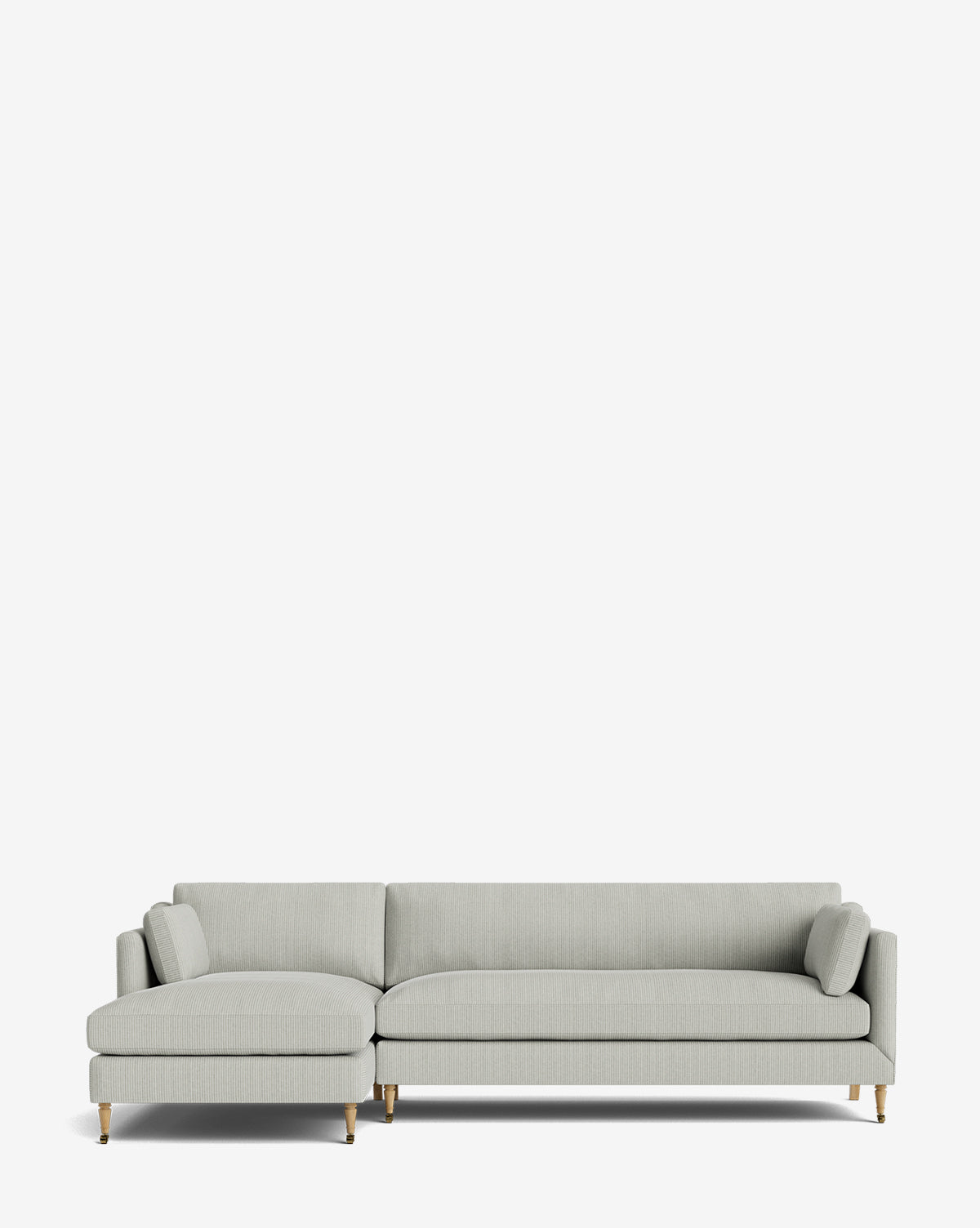 The Haverford Upholstered Left Chaise Sectional 113 is a modern, customizable light gray sofa featuring slim armrests, two cylindrical pillows, and wooden legs with gold accents, shown against a plain white background by McGee & Co.