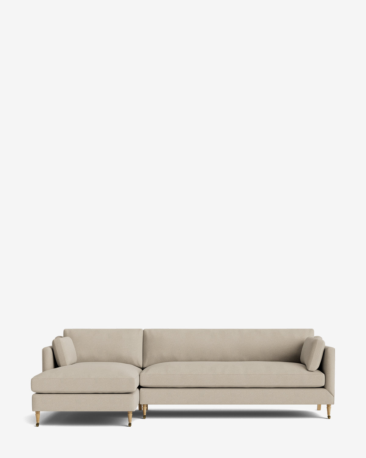 The Haverford Upholstered Left Chaise Sectional features light beige fabric, a left-side chaise, slim gold legs, and two cylindrical pillows, shown against a plain white background by McGee & Co.