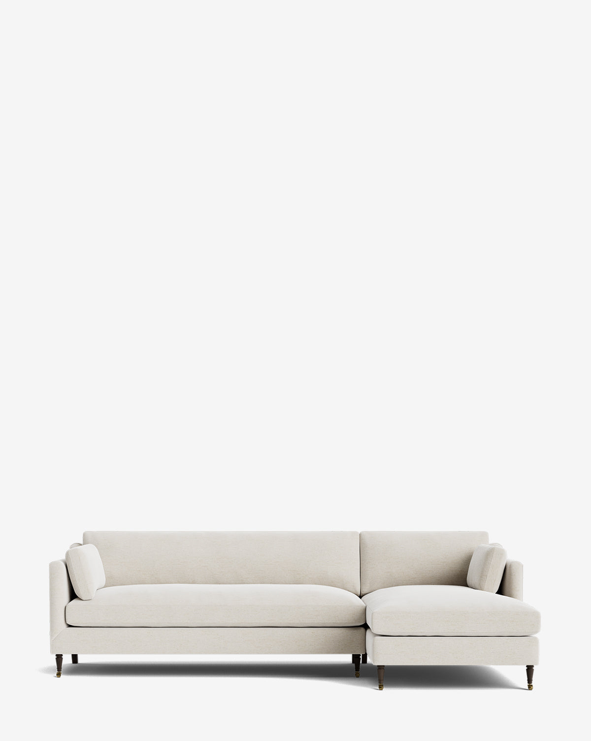 The Rowe Fine Furniture Haverford Upholstered Right Chaise Sectional features a modern, light beige design with clean lines, slim dark wooden legs, and two matching bolster pillows, shown against a plain white background. McGee & Co.