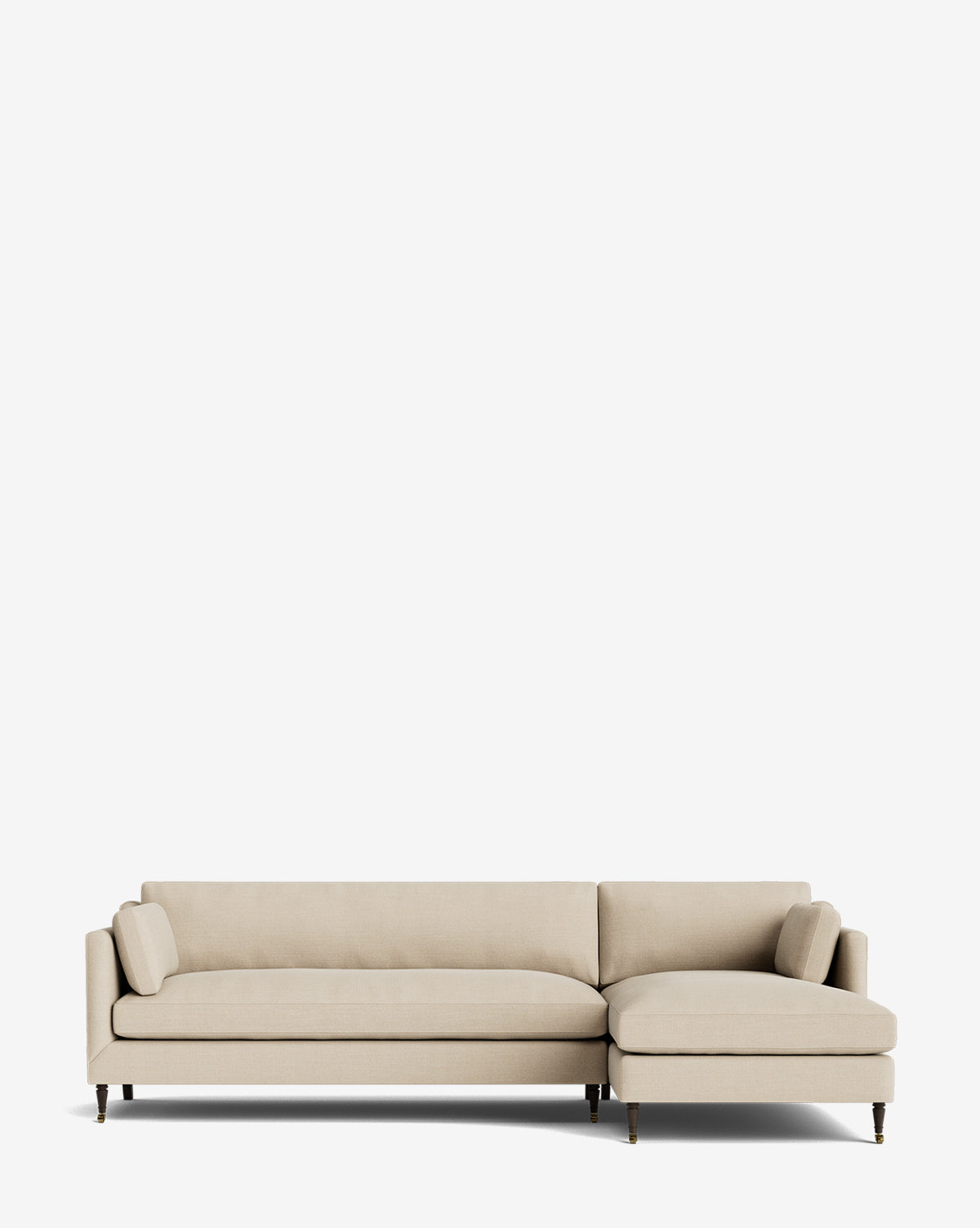 The Haverford Upholstered Right Chaise Sectional by Rowe Fine Furniture features light beige fabric, slim arms, wooden legs, and two cylindrical pillows in a right chaise design—shown against a plain white background. McGee & Co.