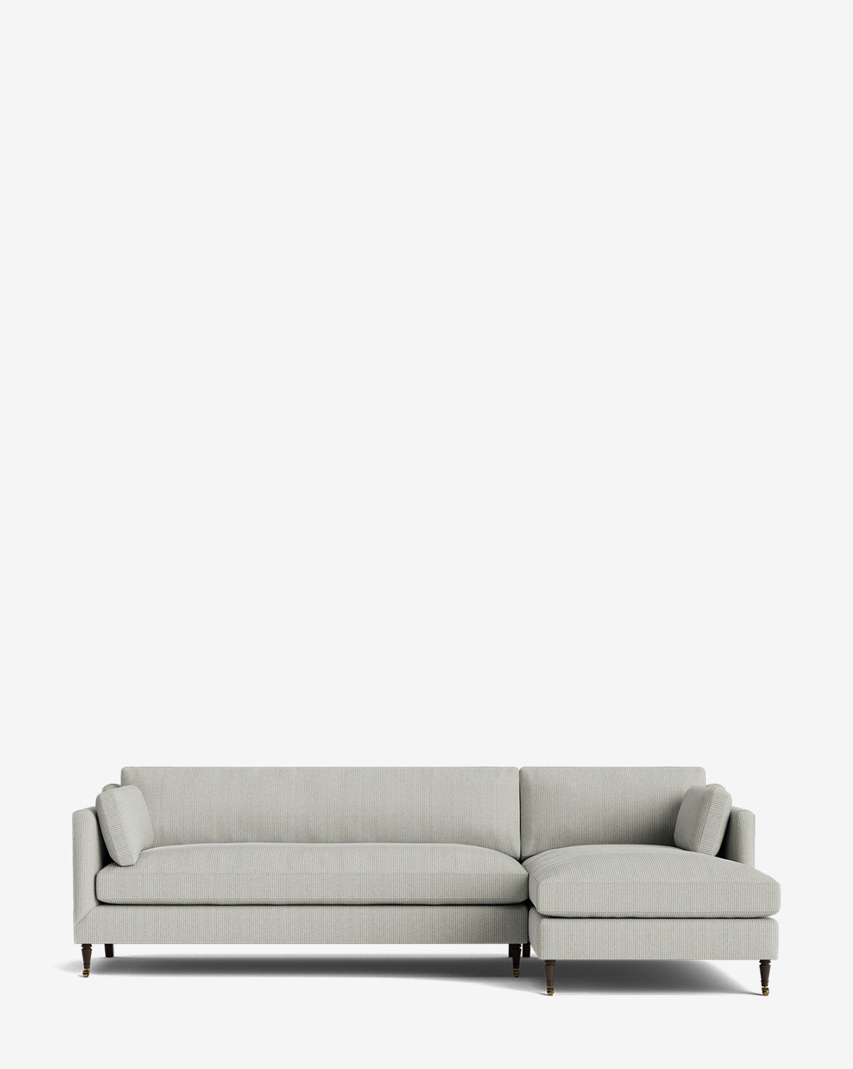 The Haverford Upholstered Right Chaise Sectional 113 is a light gray, made-to-order sectional with a right chaise, low backrest, slim armrests, and dark wood legs with brass tips, shown against a plain white background by McGee & Co.