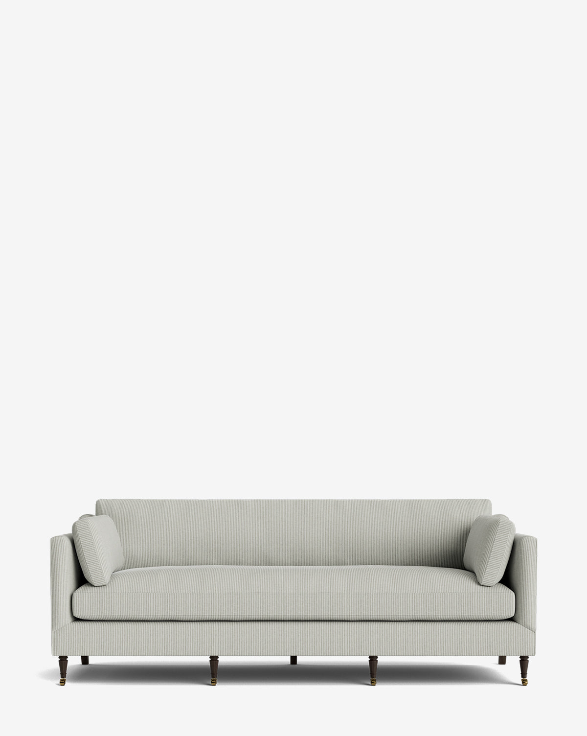 The Haverford Upholstered Sofa 90 features a light gray, modern design with clean lines, matching cylindrical bolster pillows, and dark wooden legs with brass casters, all set against a plain white background for timeless style and comfort by McGee & Co.