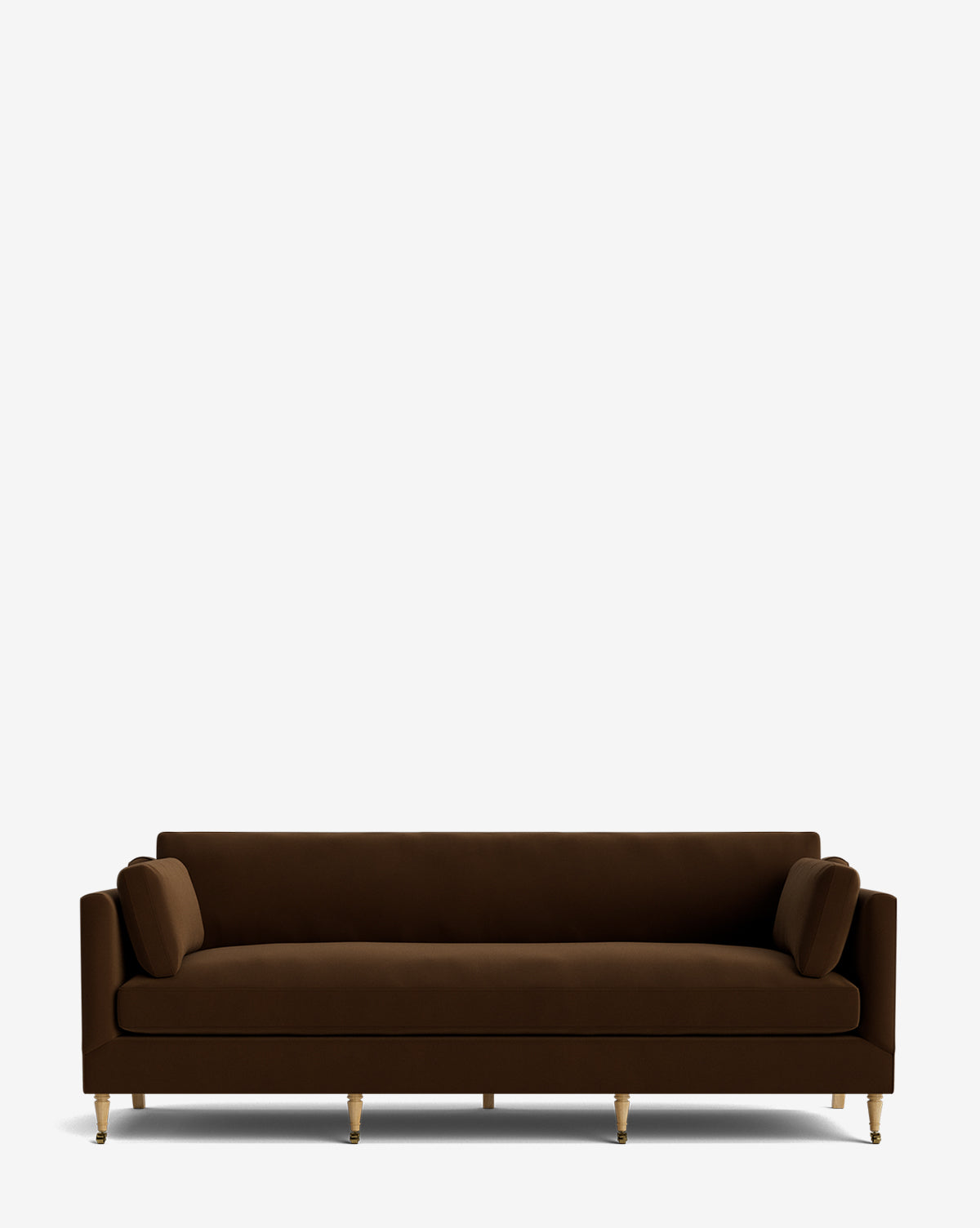 The Haverford Upholstered Sofa 90 in brown velvet features straight arms, gold-colored legs, and two matching cylindrical cushions, creating a modern handcrafted look against a plain white background by McGee & Co.