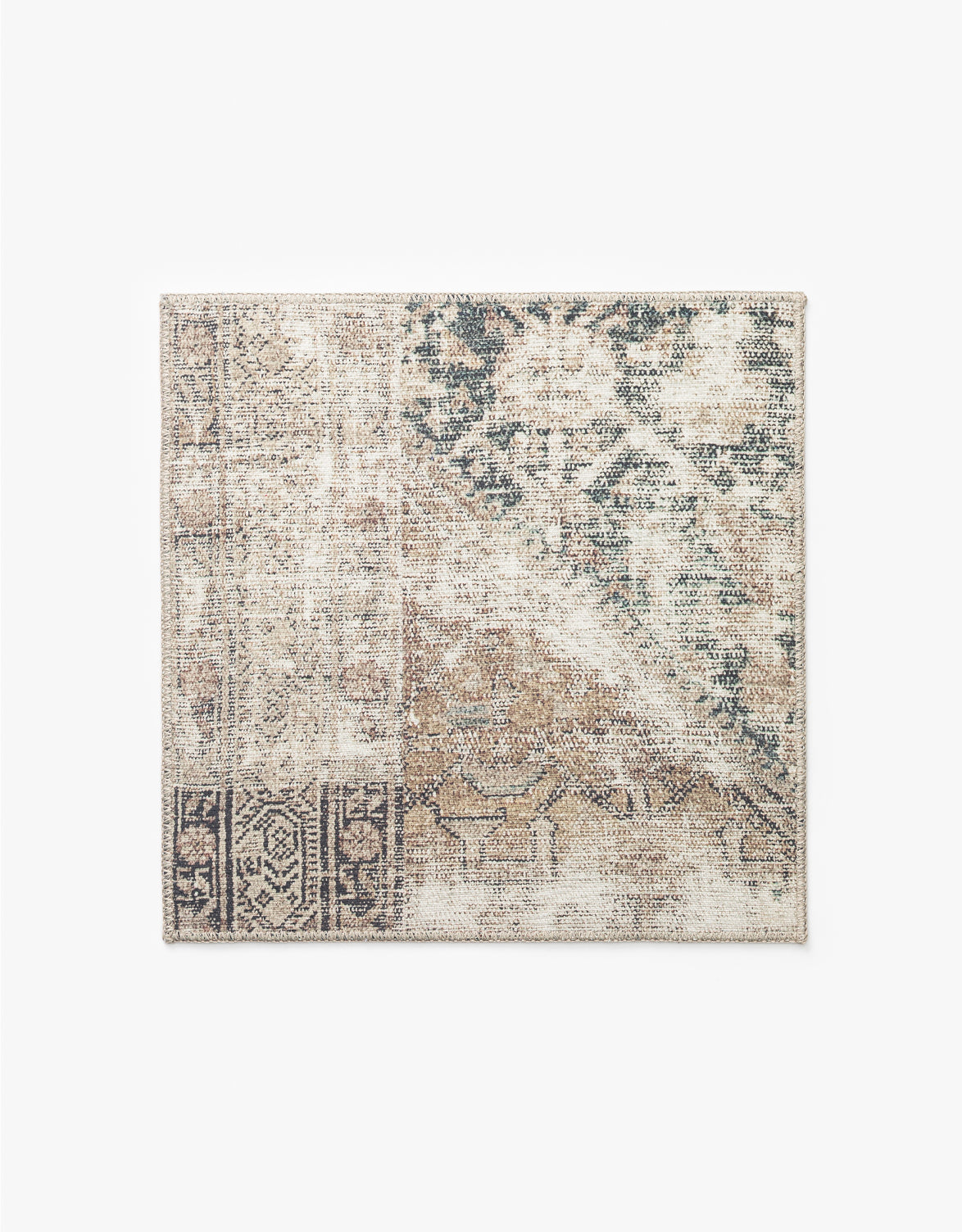 The Idalia Rug Swatch features a rectangular shape and a distressed patchwork design in beige, brown, black, and green with intricate patterns and faded traditional motifs, making it an ideal neutral palette rug for any room, by McGee & Co.