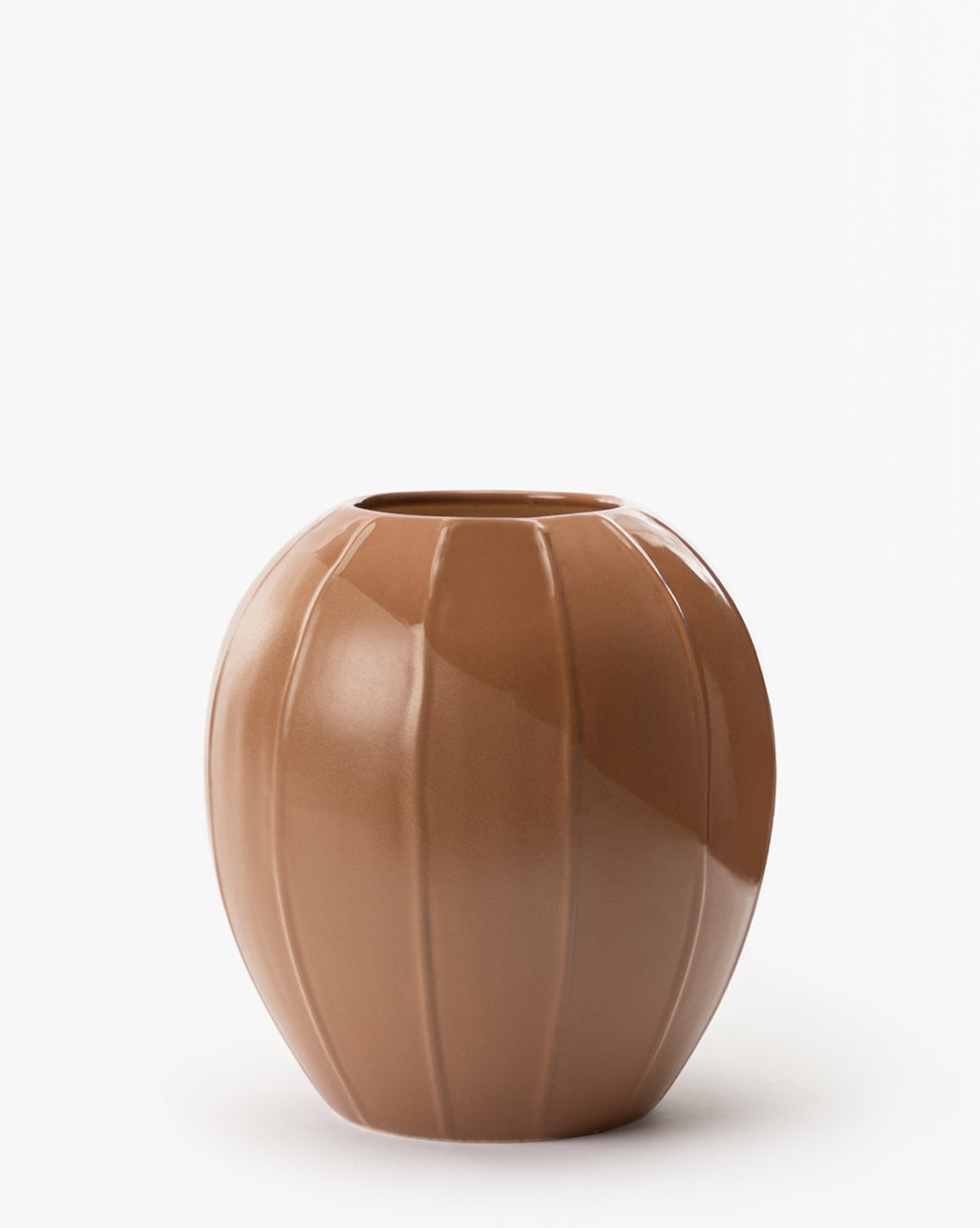 The Idris Vase is a round, glossy light brown stoneware piece with vertical grooves, a wide body, and a small circular opening, shown on a white background.