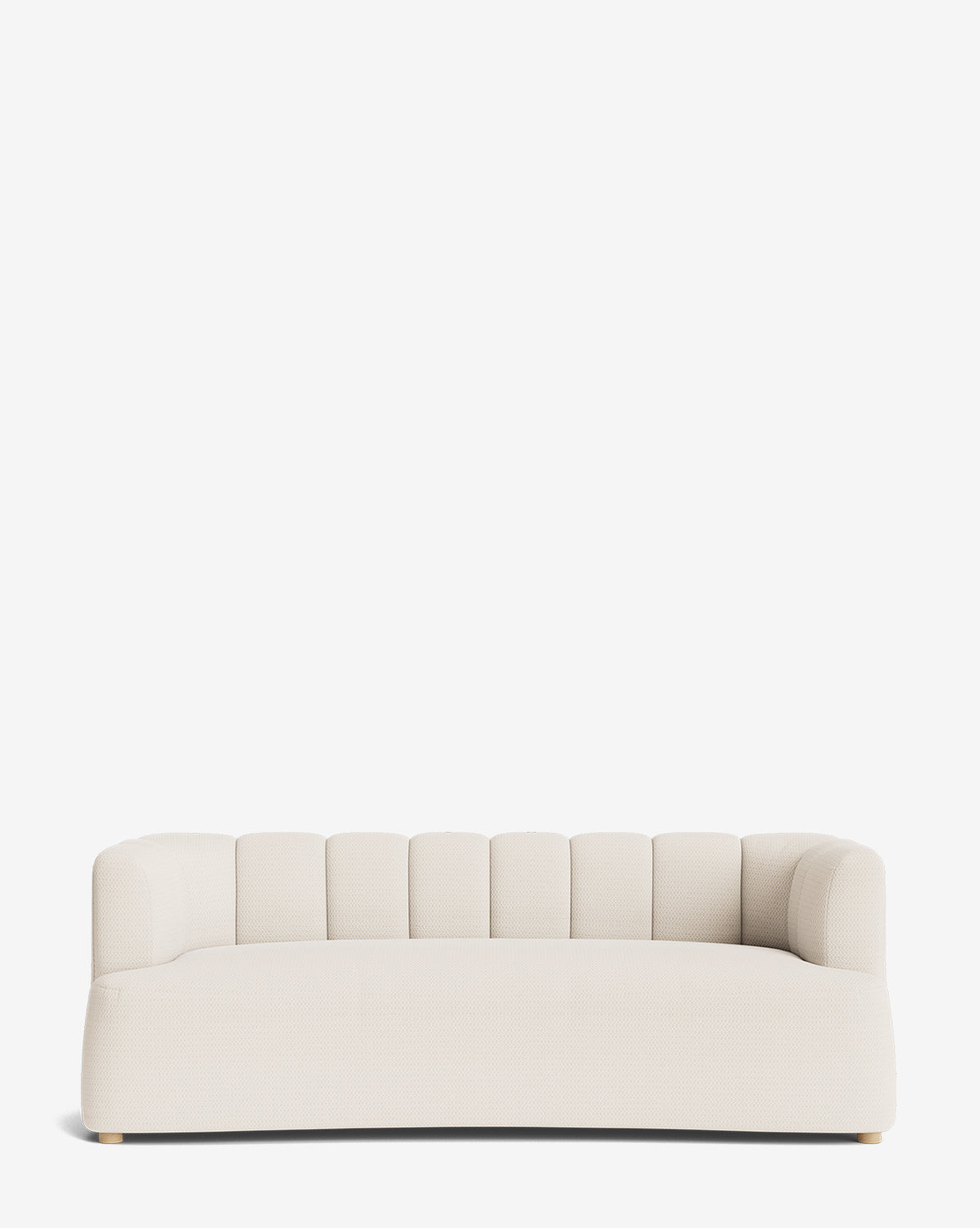 The Ines Sofa 90 is a modern, low-profile cream velvet sofa featuring a rounded backrest and subtle vertical tufting, shown against a plain white background by McGee & Co.
