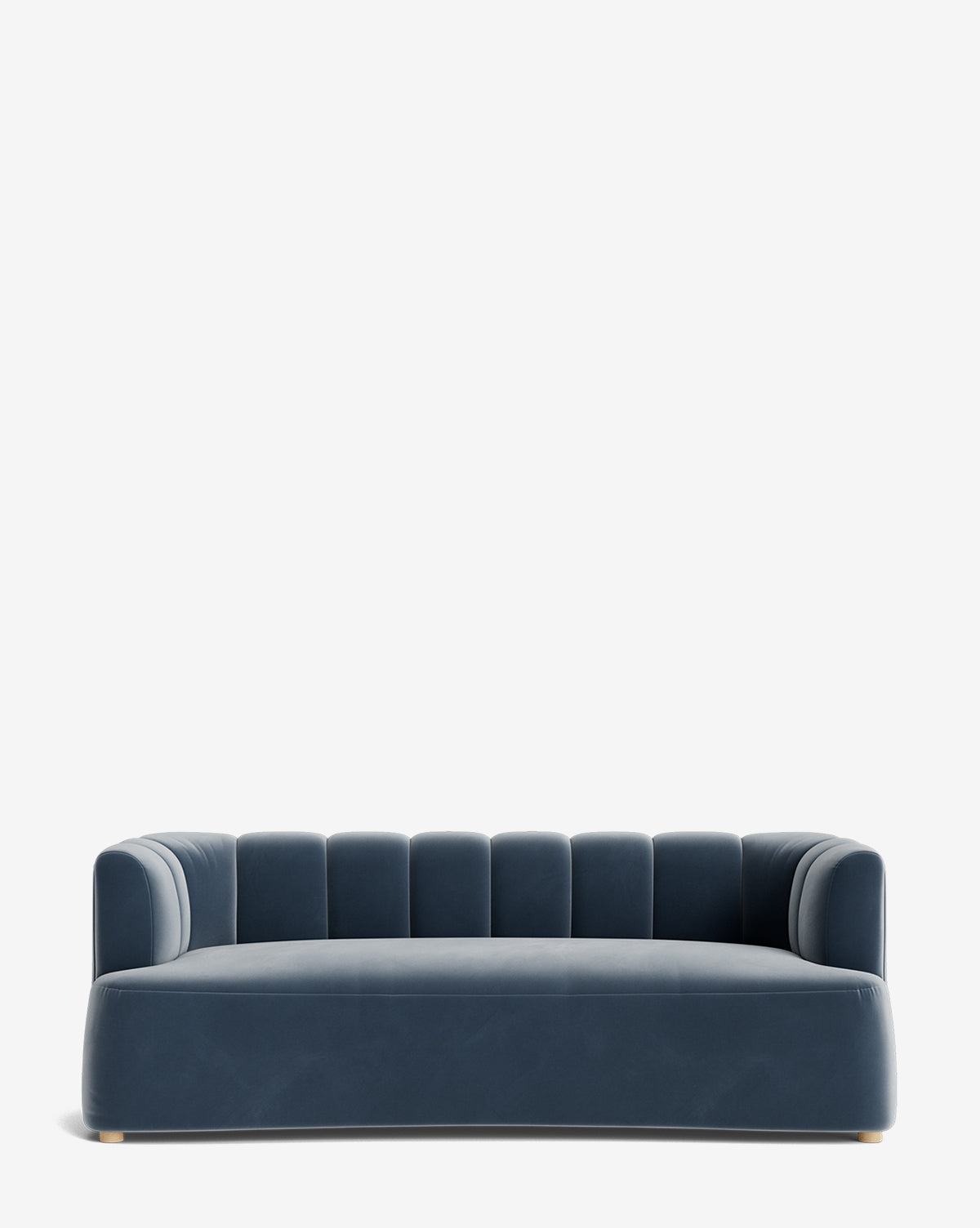 The Ines Sofa 90 is a modern deep blue velvet sofa with low, rounded arms, a wide seat, and vertical tufting on the backrest. Its subtle legs give it a sleek look against a plain white background, by McGee & Co.