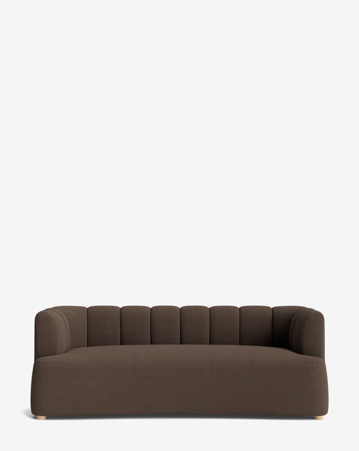 The Ines Sofa 90 is a modern dark brown velvet sofa with a low back, curved arms, and vertical channel tufting on the backrest. It features short, light-toned feet and a sleek silhouette, shown against a plain white background by McGee & Co.