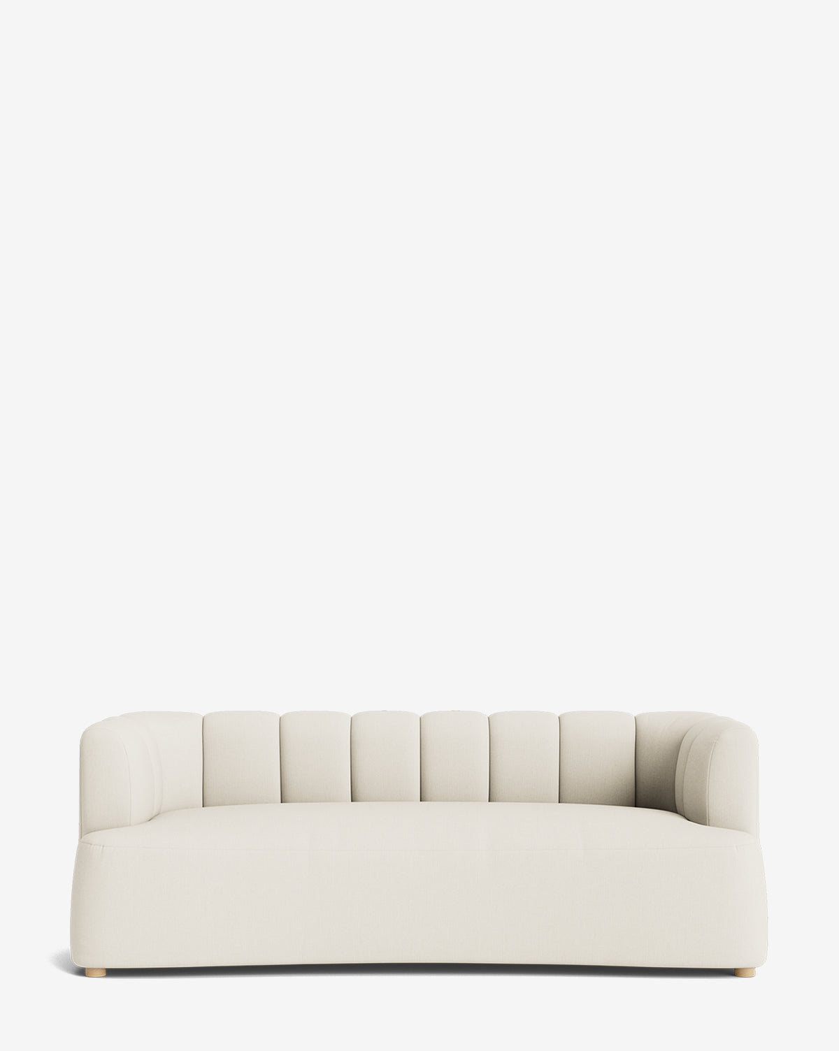 A modern, low-profile Ines Sofa 90 in cream with a curved backrest and vertical channel tufting, set against a plain white background by McGee & Co.