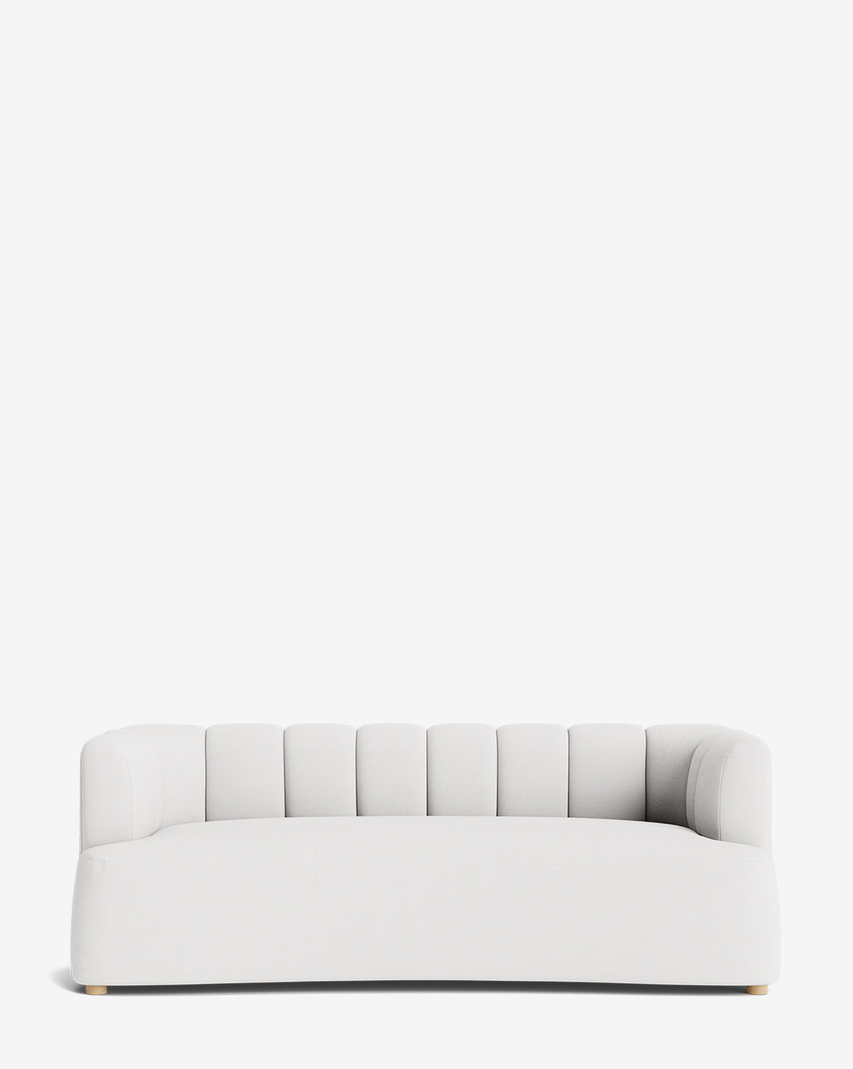The Ines Sofa 90 is a modern sofa with a rounded backrest featuring vertical channel tufting, low arms, and short light-colored wooden legs, shown against a plain white background by McGee & Co.