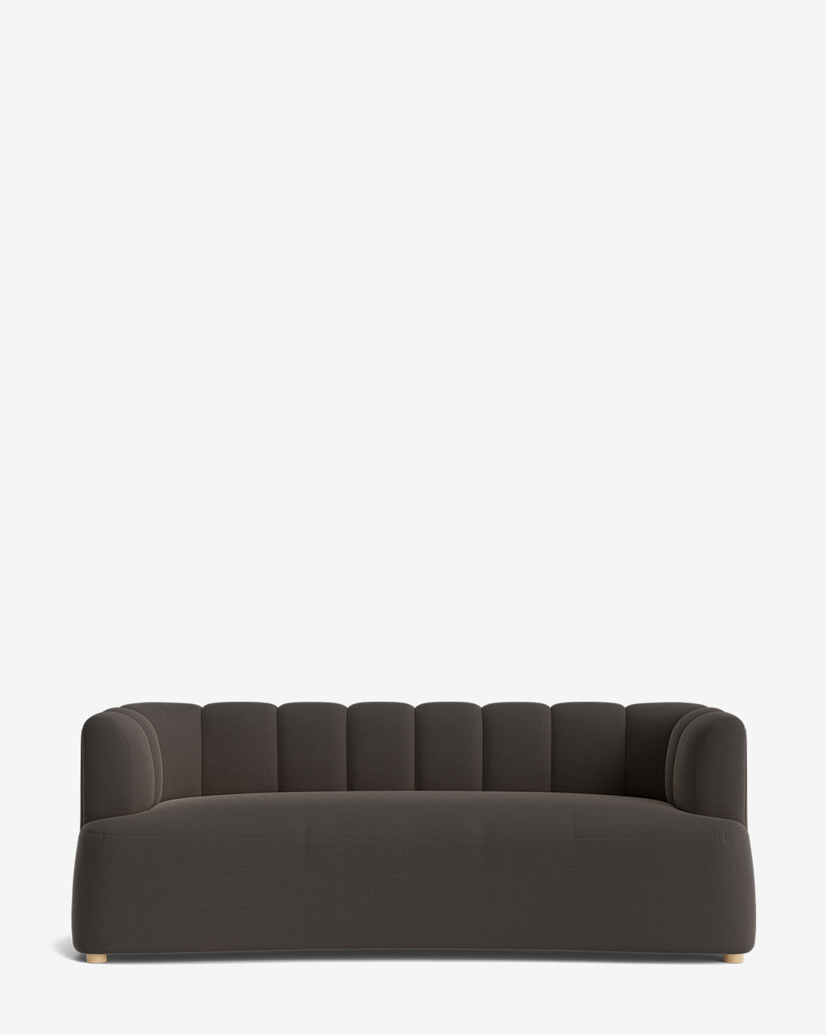 The Ines Sofa 90 is a modern dark gray velvet sofa with a low, rounded backrest, vertical tufted details, and gold-tone feet, shown on a plain white background by McGee & Co.