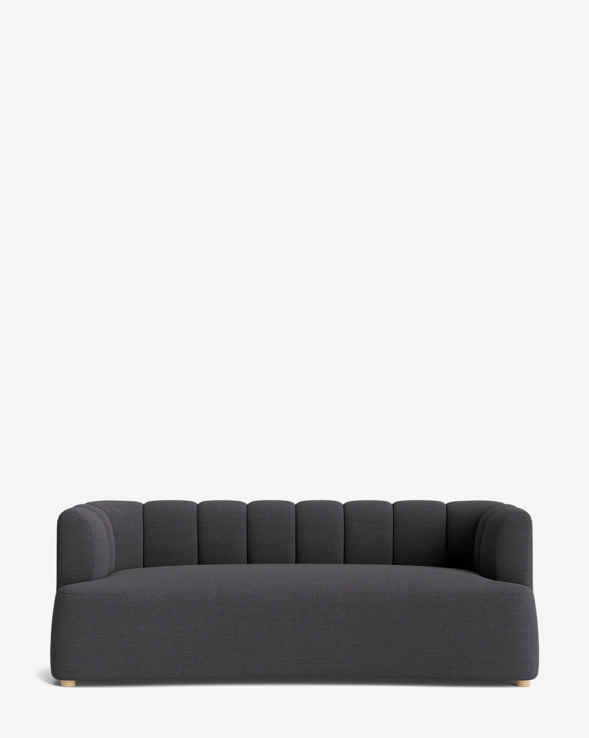 The Ines Sofa 90 features modern dark gray upholstery, a low back, vertically-stitched rounded cushions, wide seat, short light feet, and a sleek silhouette set against a plain white background by McGee & Co.