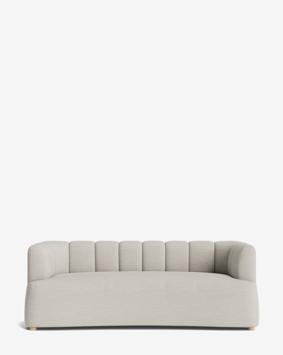 The Ines Sofa 90 is a modern, light gray velvet sofa with a low back and sides, vertical channel tufting, rounded edges, and small discreet wooden feet, set against a plain white background by McGee & Co.
