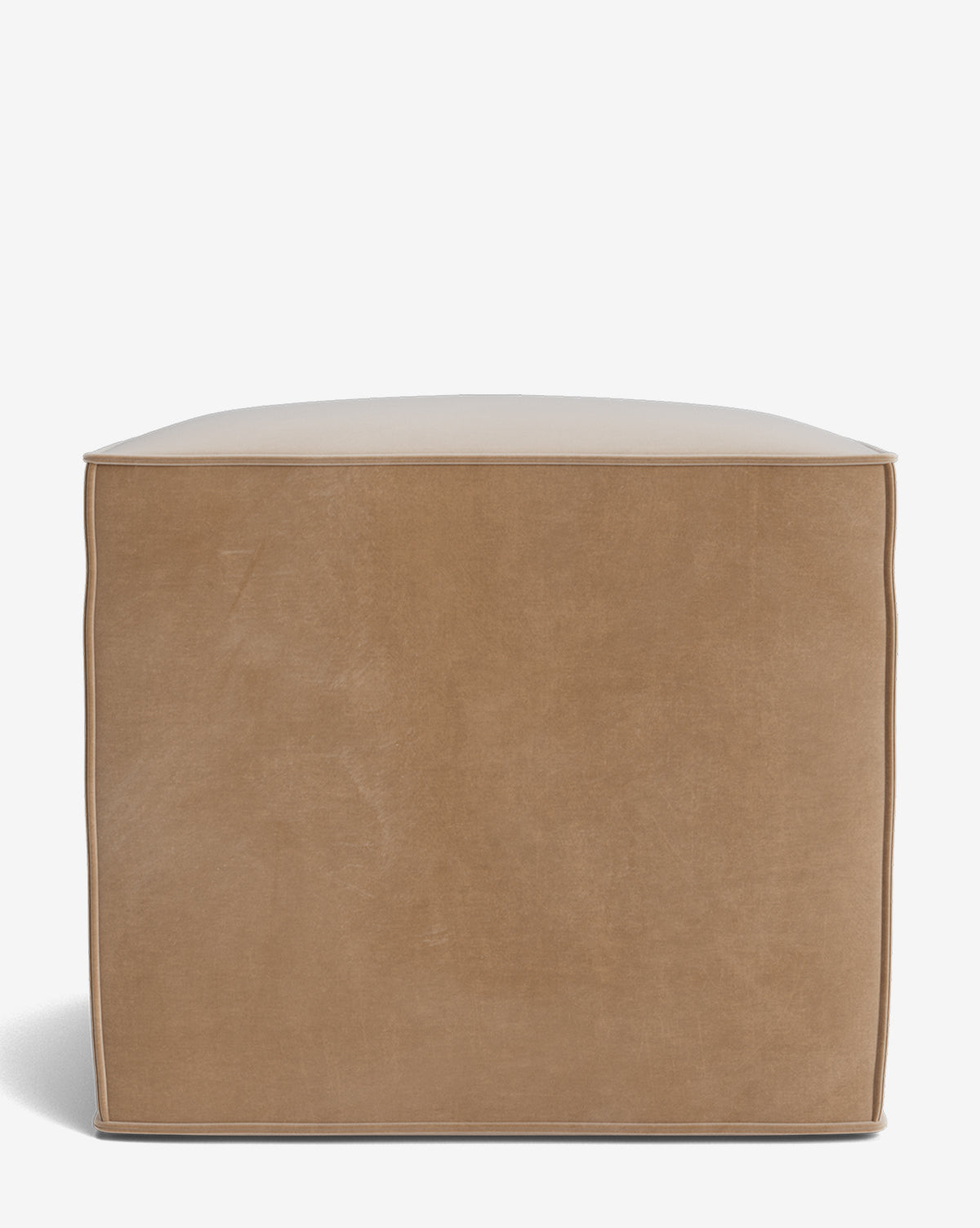 The Johannes Cube is a cube-shaped light brown leather pouf ottoman with visible edge stitching, offering a stylish cushioned seat, pictured on a white background by McGee & Co.