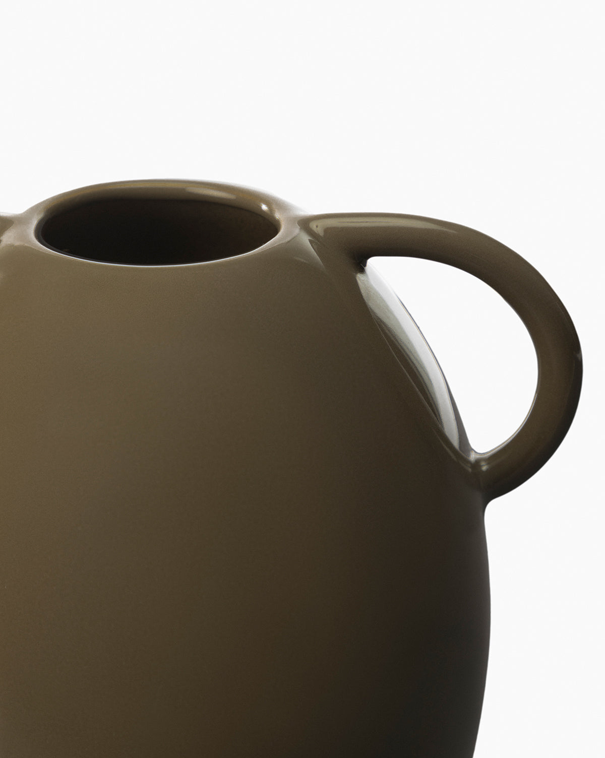 A close-up of the Leylani Vase, showcasing its smooth brown ceramic finish, rounded body, and curved handle against a plain white background.