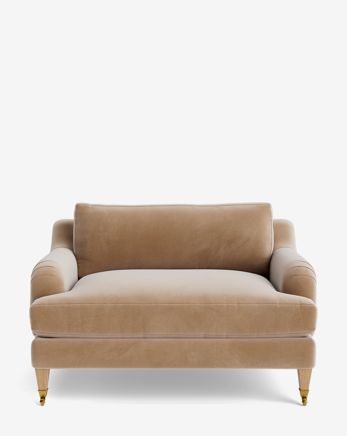 The Lucille English Roll Arm Chair and a Half features beige velvet upholstery, plush down-wrapped cushions, classic curved armrests, and wooden legs with brass casters on the front, by McGee & Co.