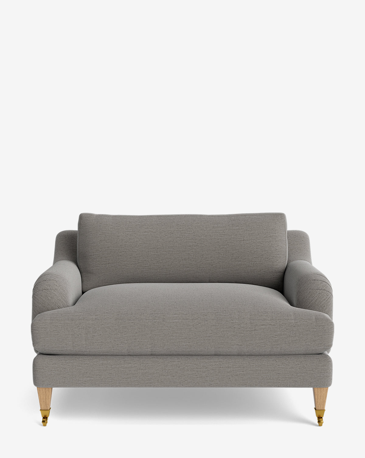 The Lucille English Roll Arm Chair and a Half features grey upholstery, rounded arms, down-wrapped cushions, wooden legs with small brass casters on the front legs, and is shown against a plain white background by McGee & Co.