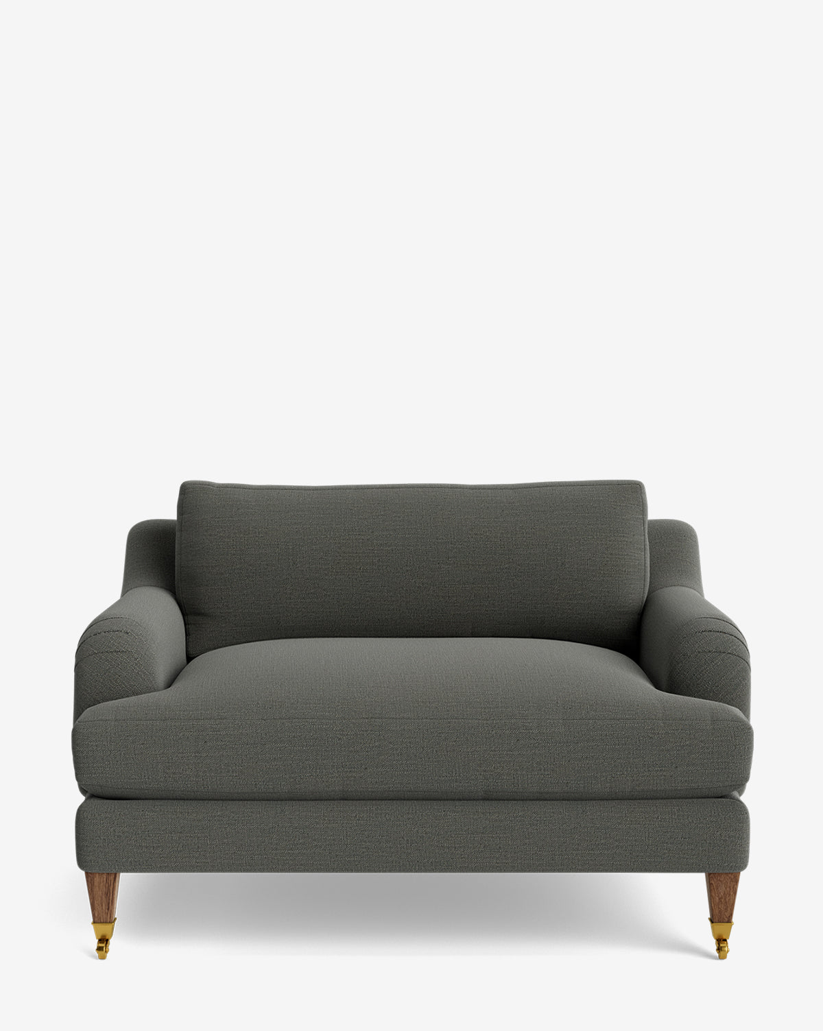 The Lucille English Roll Arm Chair and a Half is a dark gray customizable chair with English roll arms, a single down-wrapped back cushion, deep seat cushion, and wooden legs with brass castors, shown against a plain white background by McGee & Co.