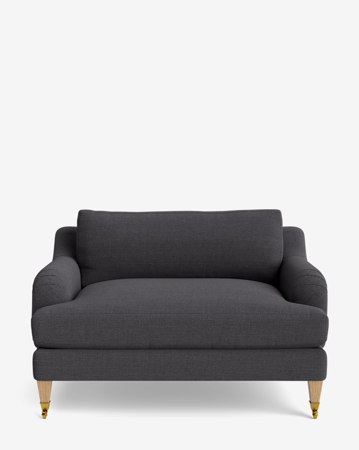 The Lucille English Roll Arm Chair and a Half features a dark gray finish, down-wrapped cushions, rounded arms, straight backrest, and wooden legs—two with brass casters—displayed against a plain white background by McGee & Co.